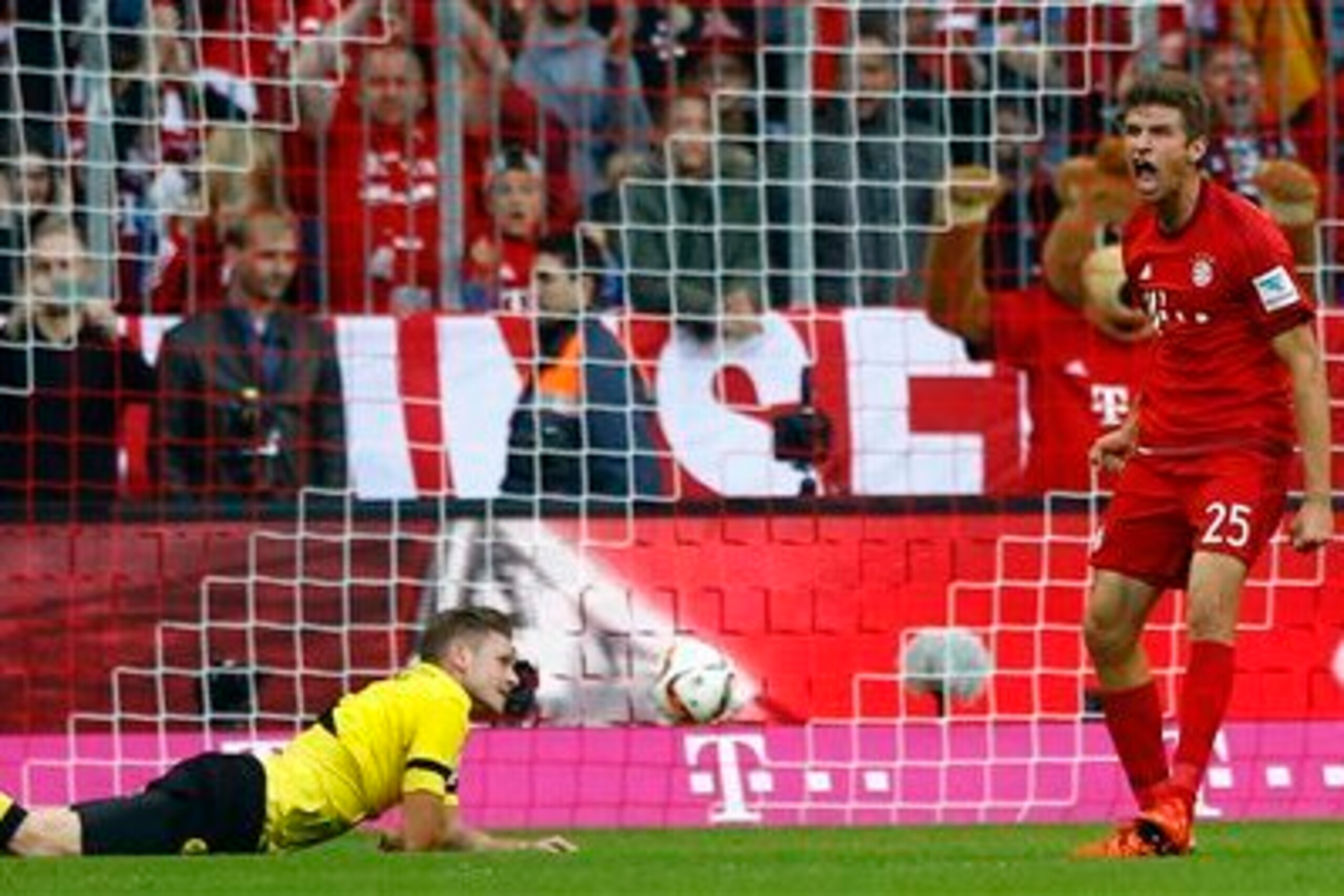 Lukasz Piszczek on the ground while Thomas Muller celebrates during Dortmund's 5-1 loss at Munich.