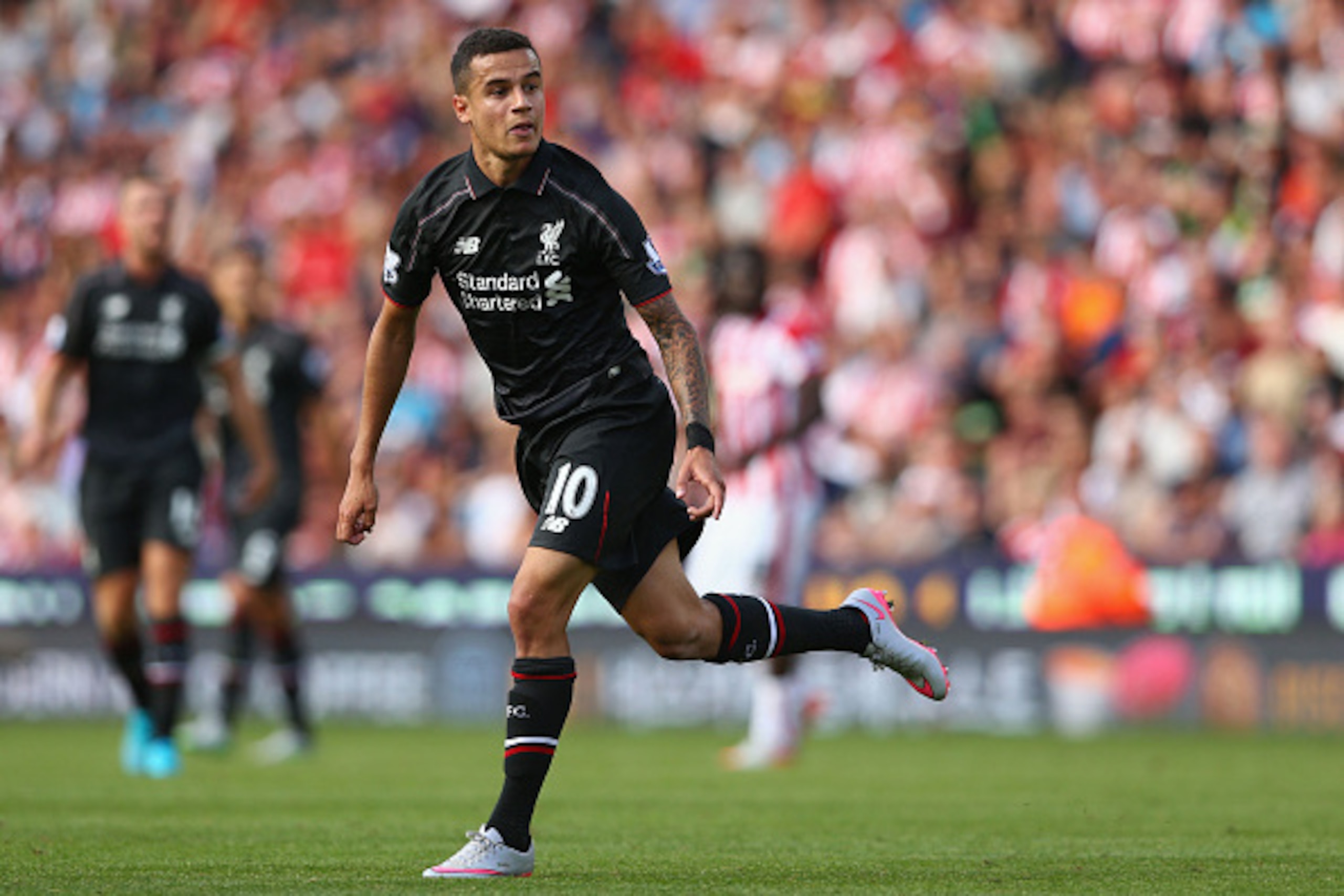 STOKE ON TRENT, ENGLAND - AUGUST 09:  Philippe Coutinho of Liverpool looks on as he scores their first goal during the Barclays Premier League match between Stoke City and Liverpool at Brittania Stadium on August 9, 2015 in Stoke on Trent, England.  (Phot