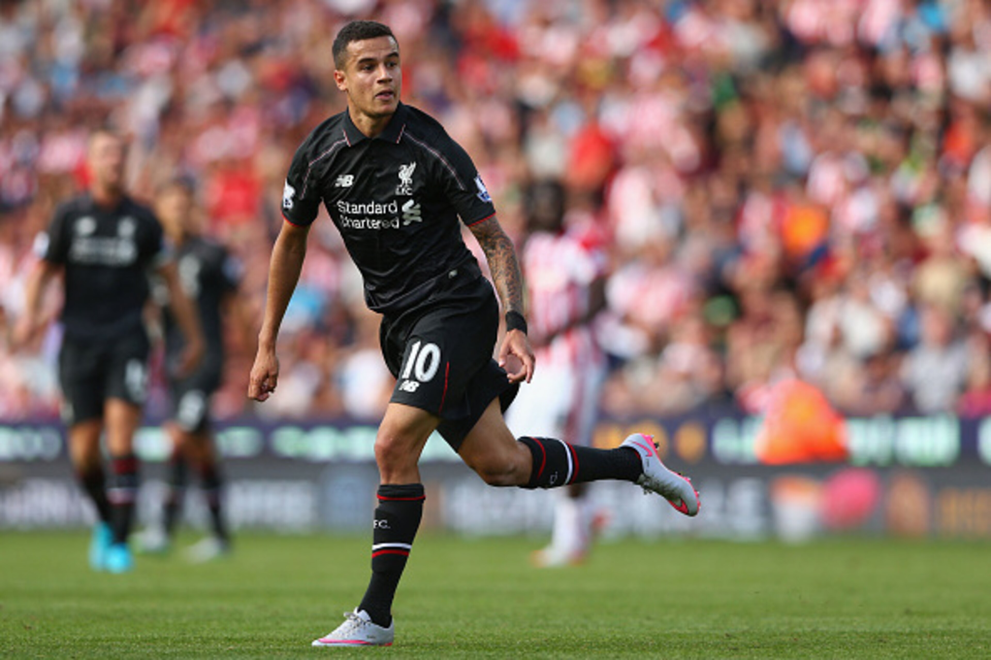 STOKE ON TRENT, ENGLAND - AUGUST 09:  Philippe Coutinho of Liverpool looks on as he scores their first goal during the Barclays Premier League match between Stoke City and Liverpool at Brittania Stadium on August 9, 2015 in Stoke on Trent, England.  (Phot