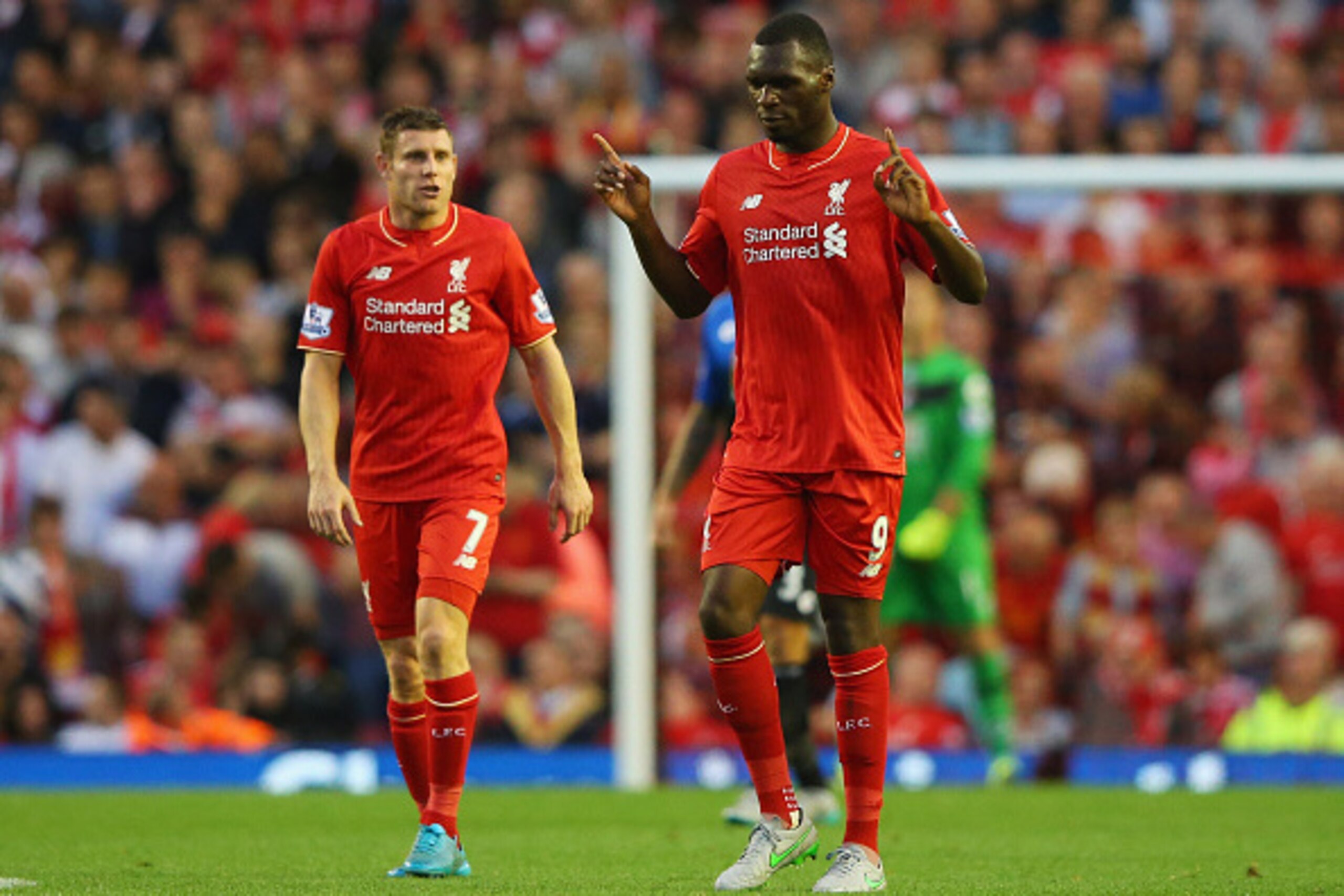 LIVERPOOL, ENGLAND - AUGUST 17:  Christian Benteke of Liverpool (9) celebrates alongside James Milner (7) as he scores their first goal during the Barclays Premier League match between Liverpool and A.F.C. Bournemouth at Anfield on August 17, 2015 in Live