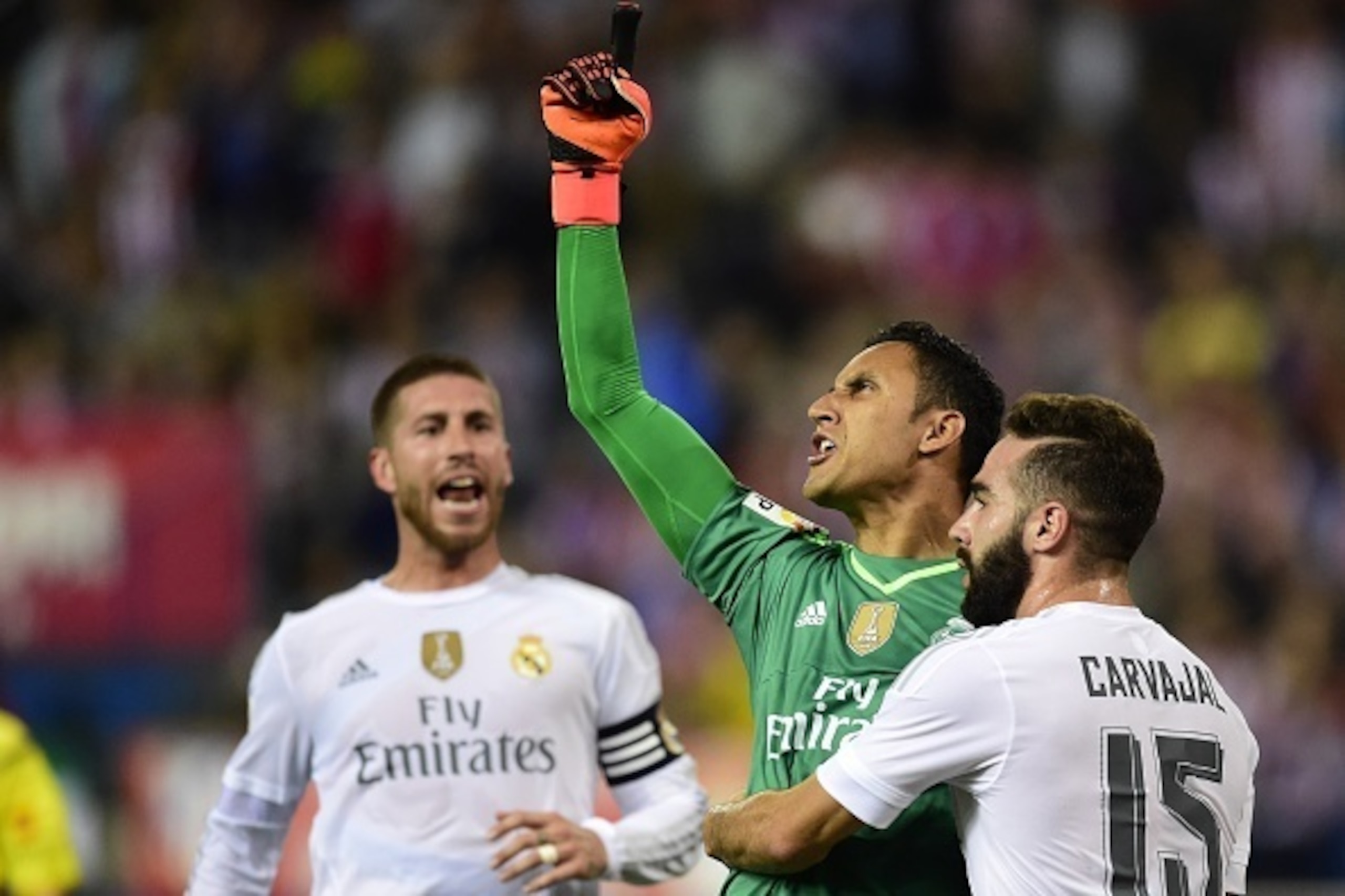 Real Madrid's Costa Rican goalkeeper Keylor Navas (2ndR) reacts after stopping a penalty kick past Real Madrid's defender Dani Carvajal (R) during the Spanish league football match Club Atletico de Madrid vs Real Madrid CF at the Vicente Calderon stadium 