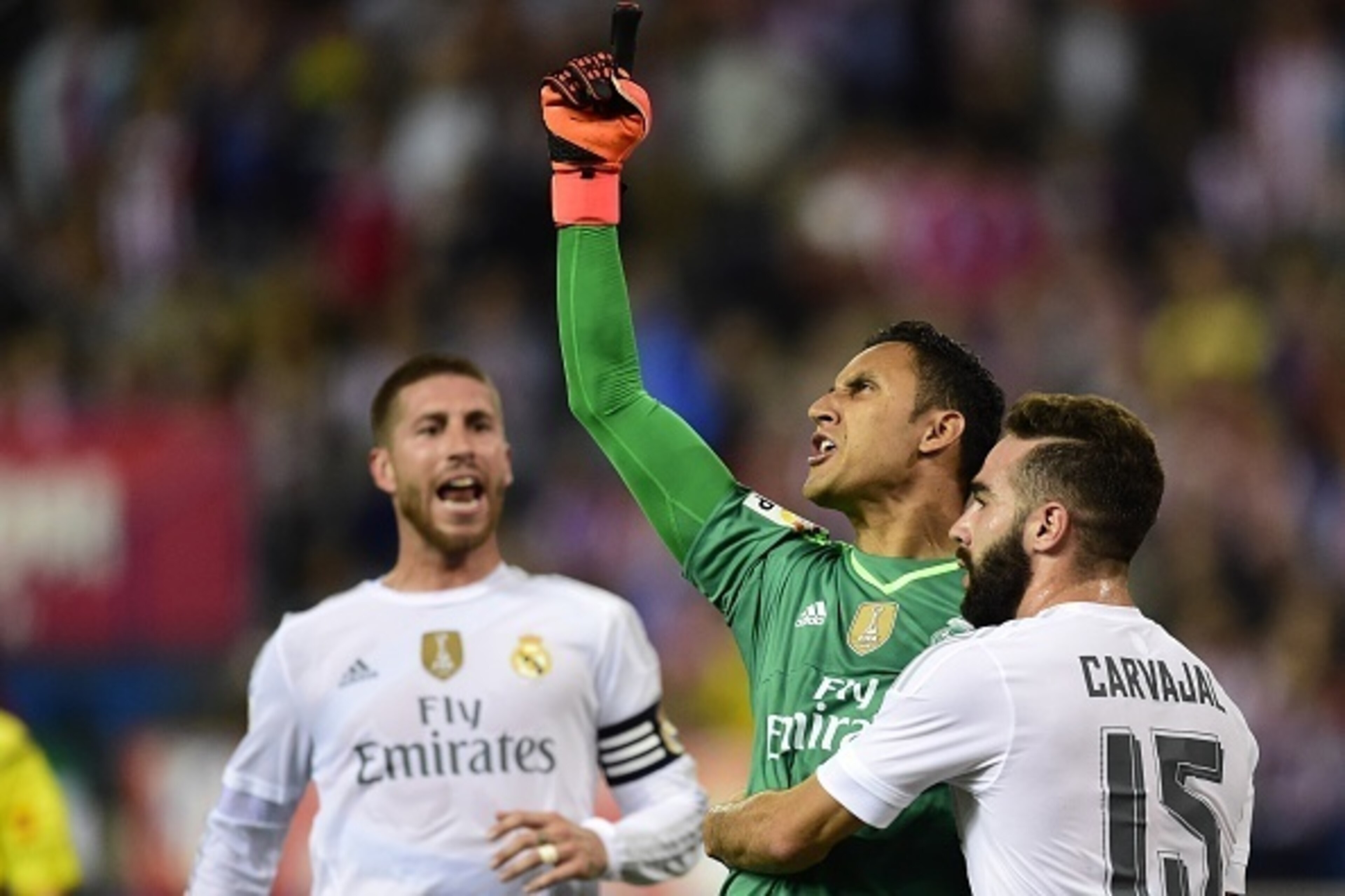 Real Madrid's Costa Rican goalkeeper Keylor Navas (2ndR) reacts after stopping a penalty kick past Real Madrid's defender Dani Carvajal (R) during the Spanish league football match Club Atletico de Madrid vs Real Madrid CF at the Vicente Calderon stadium 