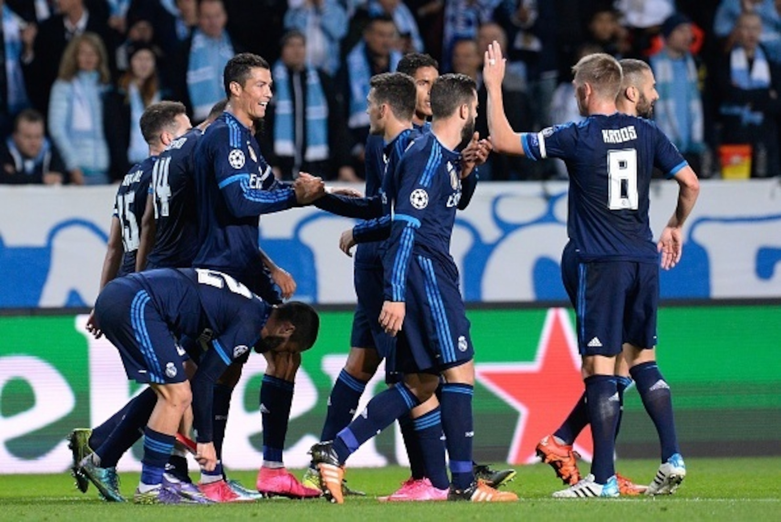 Real Madrid's Portuguese forward Cristiano Ronaldo celebrates after scoring the opening goal with his teammates during the UEFA Champions League first-leg Group A football match between Malmo FF and Real Madrid CF at the Swedbank Stadion, in Malmo, Sweden