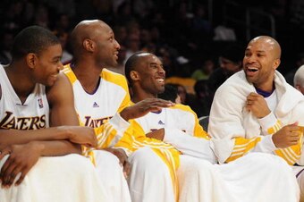 LOS ANGELES, CA - DECEMBER 6:   (L-R)Andrew Bynum #21, Lamar Odom #7, Kobe Bryant #24 and Derek Fisher #2 of the Los Angeles Lakers talk on the bench during the game against the Phoenix Suns at Staples Center on December 6, 2009 in Los Angeles, California