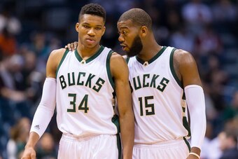 Oct 10, 2015; Milwaukee, WI, USA; Milwaukee Bucks center Greg Monroe (15) talks with forward Giannis Antetokounmpo (34) during the second quarter against the Detroit Pistons at BMO Harris Bradley Center. Mandatory Credit: Jeff Hanisch-USA TODAY Sports