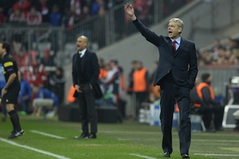 Arsenal's French manager Arsene Wenger (R) and Bayern Munich's Spanish head coach Pep Guardiola react during the UEFA Champions League last 16 second-leg football match FC Bayern Munich vs FC Arsenal in Munich, southern Germany, on March 11, 2014.   AFP P