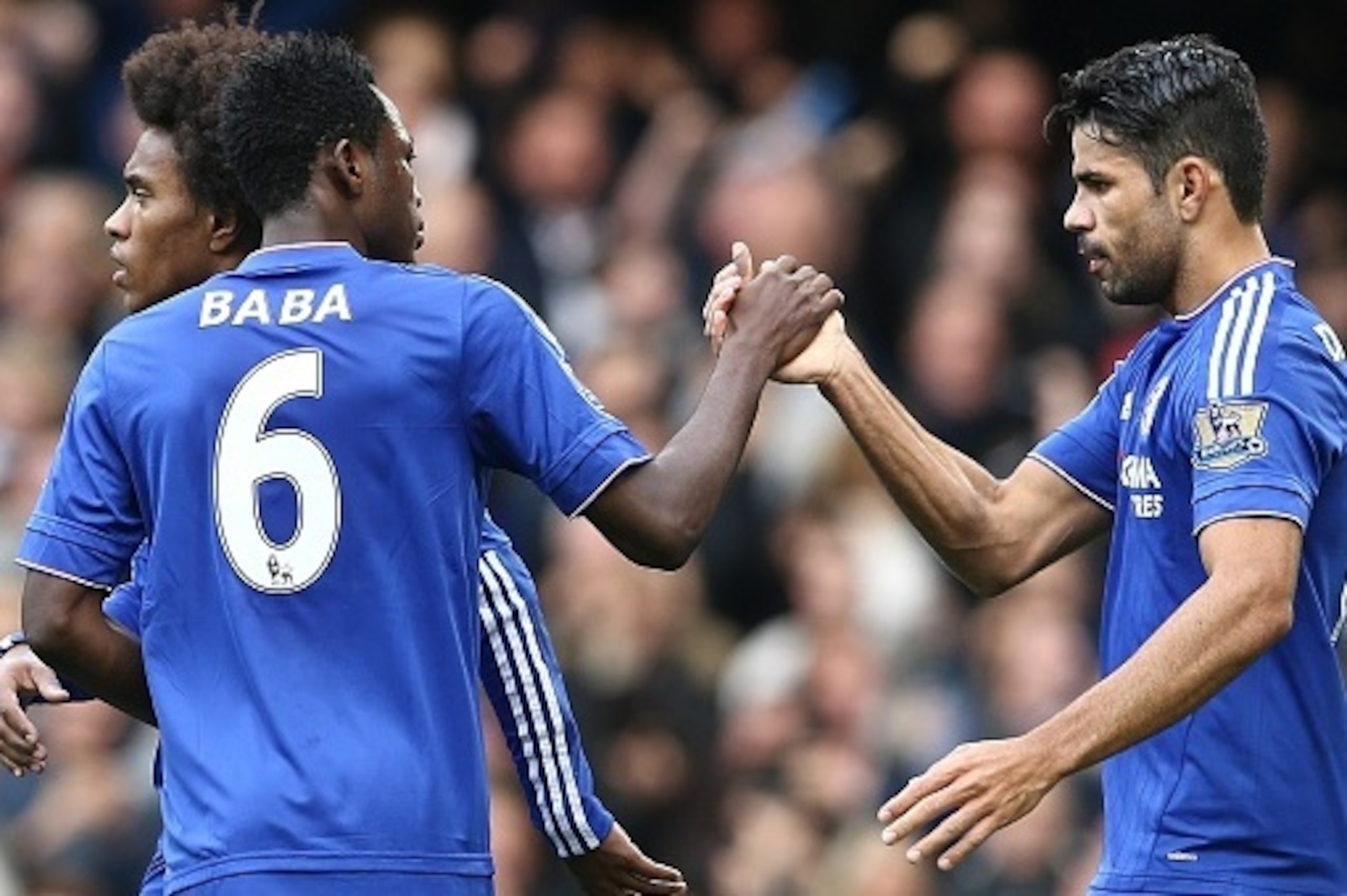Chelsea's Brazilian-born Spanish striker Diego Costa (R) celebrates with Chelsea's Ghanaian defender Baba Rahman after Costa scored his team's first goal during the English Premier League football match between Chelsea and Aston Villa at Stamford Bridge i