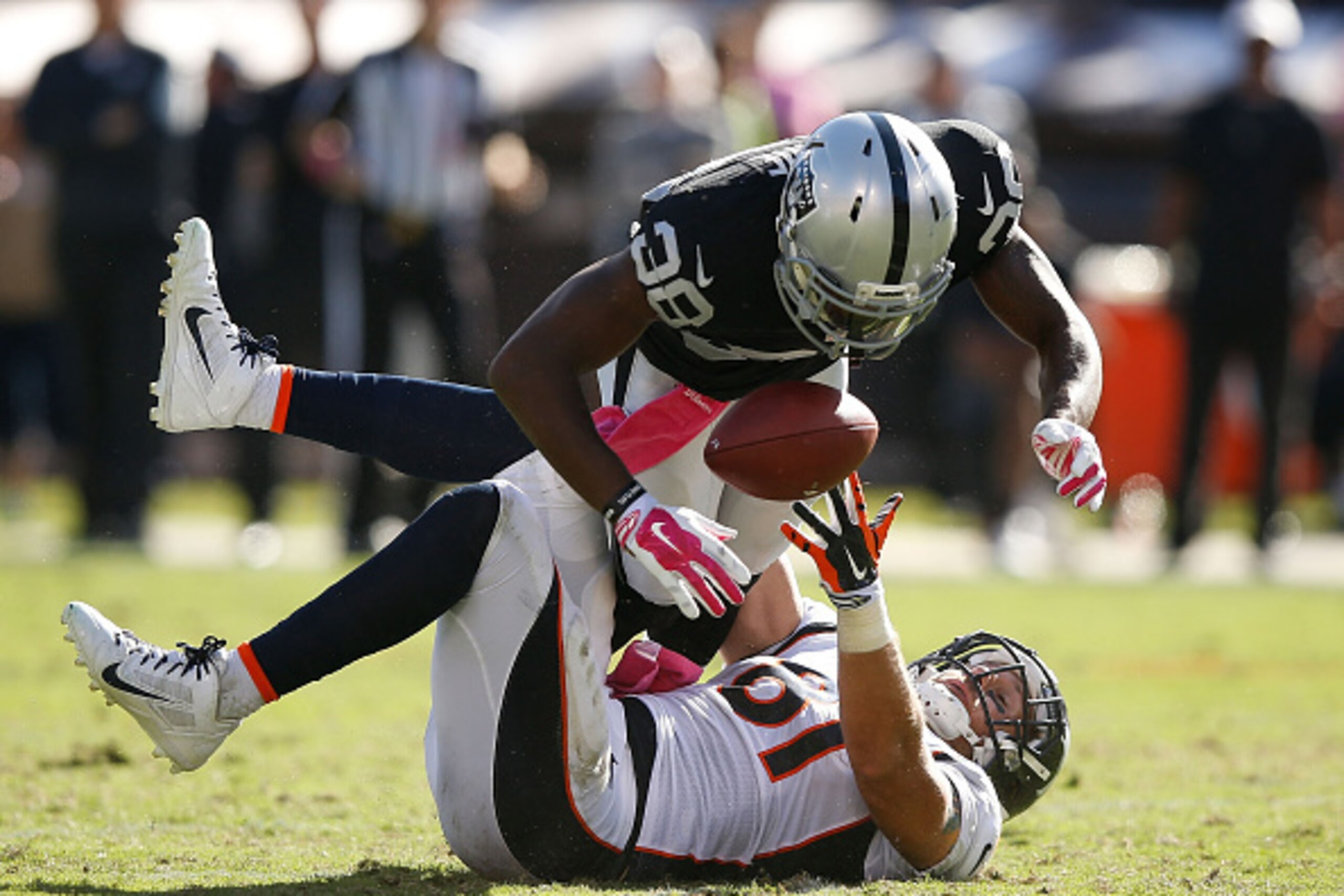 OAKLAND, CA - OCTOBER 11: Matt Paradis #61 of the Denver Broncos misses a pass under pressure from T.J. Carrie #38 of the Oakland Raiders in the fourth quarter at O.co Coliseum on October 11, 2015 in Oakland, California. (Photo by Ezra Shaw/Getty Images)