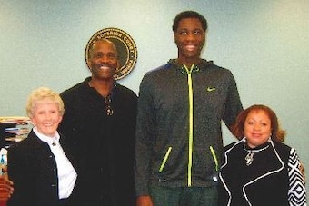 Roosevelt Barnes and Caleb Swanigan pose with their lawyer (left) and the magistrate who oversaw the case (right) on the day the adoption was finalized.