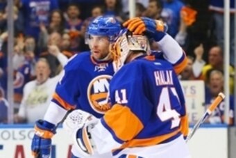 Apr 25, 2015; Uniondale, NY, USA; New York Islanders center John Tavares (91) congratulates winning goaltender Jaroslav Halak (41) after defeating the Washington Capitals in game six of the first round of the 2015 Stanley Cup Playoffs at Nassau Veterans M