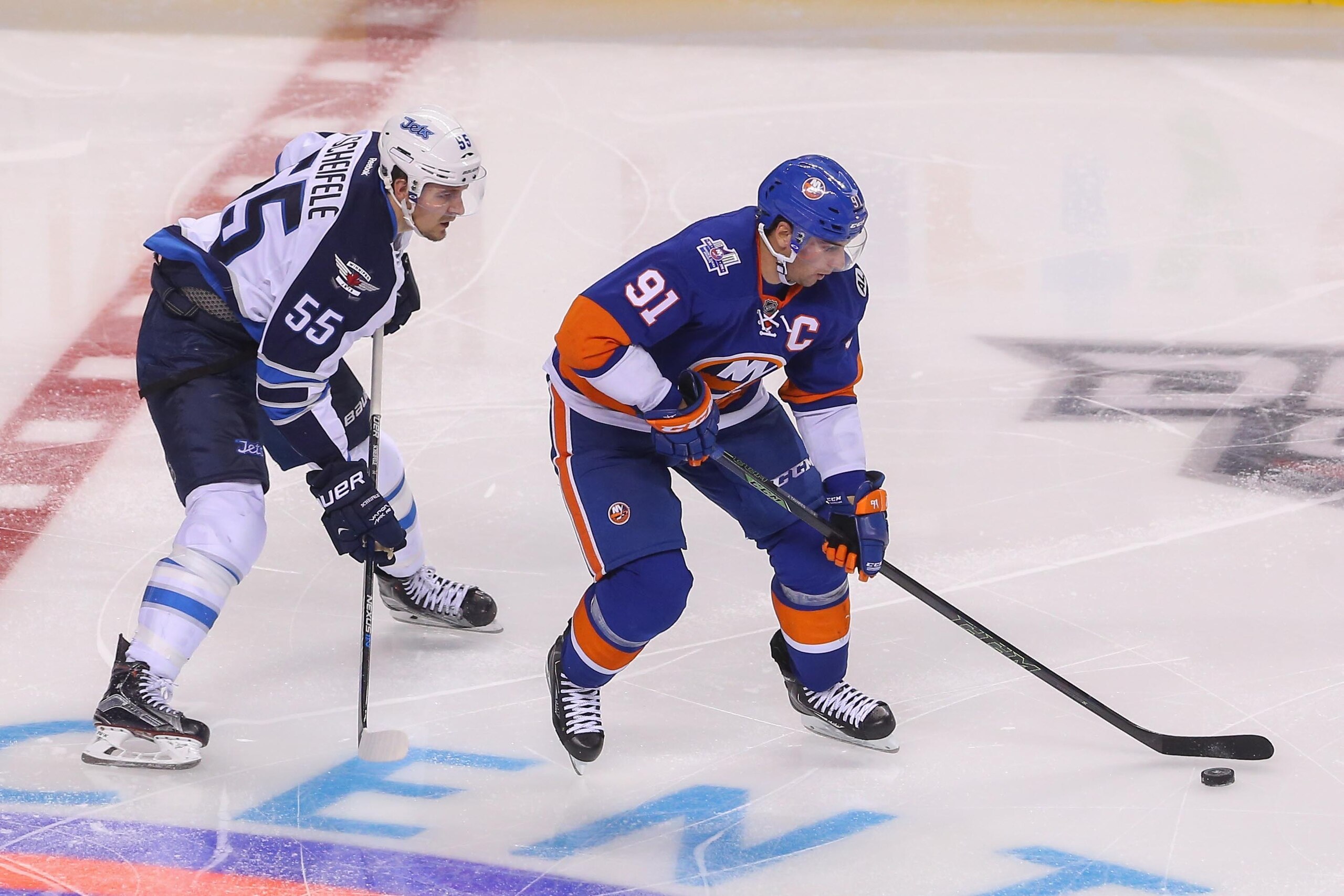 Oct 12, 2015; Brooklyn, NY, USA; New York Islanders center John Tavares (91) skates with the puck while being defended by Winnipeg Jets center Mark Scheifele (55) during the third period at Barclays Center. The Islanders defeated the Jets 4-2. Mandatory Oct 12, 2015; Brooklyn, NY, USA; New York Islanders center John Tavares (91) skates with the puck while being defended by Winnipeg Jets center Mark Scheifele (55) during the third period at Barclays Center. The Islanders defeated the Jets 4-2. Mandatory