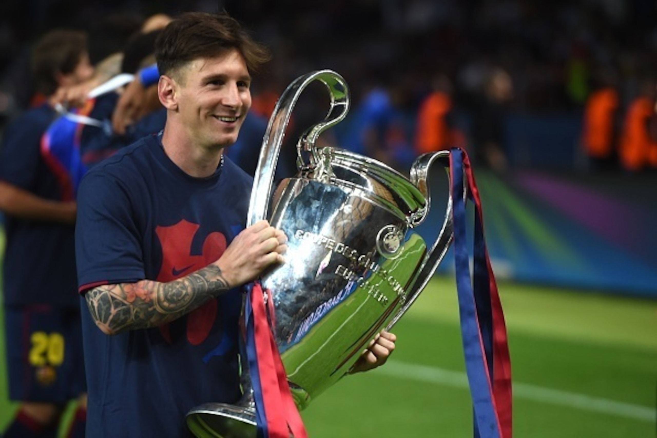 Barcelona's Argentinian forward Lionel Messi holds the trophy after the UEFA Champions League Final football match between Juventus and FC Barcelona at the Olympic Stadium in Berlin on June 6, 2015. FC Barcelona won the match 1-3.        AFP PHOTO / PATRI