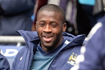 Manchester City's Ivorian midfielder Yaya Toure sits in the dugout ahead of the English Premier League football match between Manchester City and Queens Park Rangers at the Etihad Stadium in Manchester, northwest England, on May 10, 2015.  AFP PHOTO / OLI