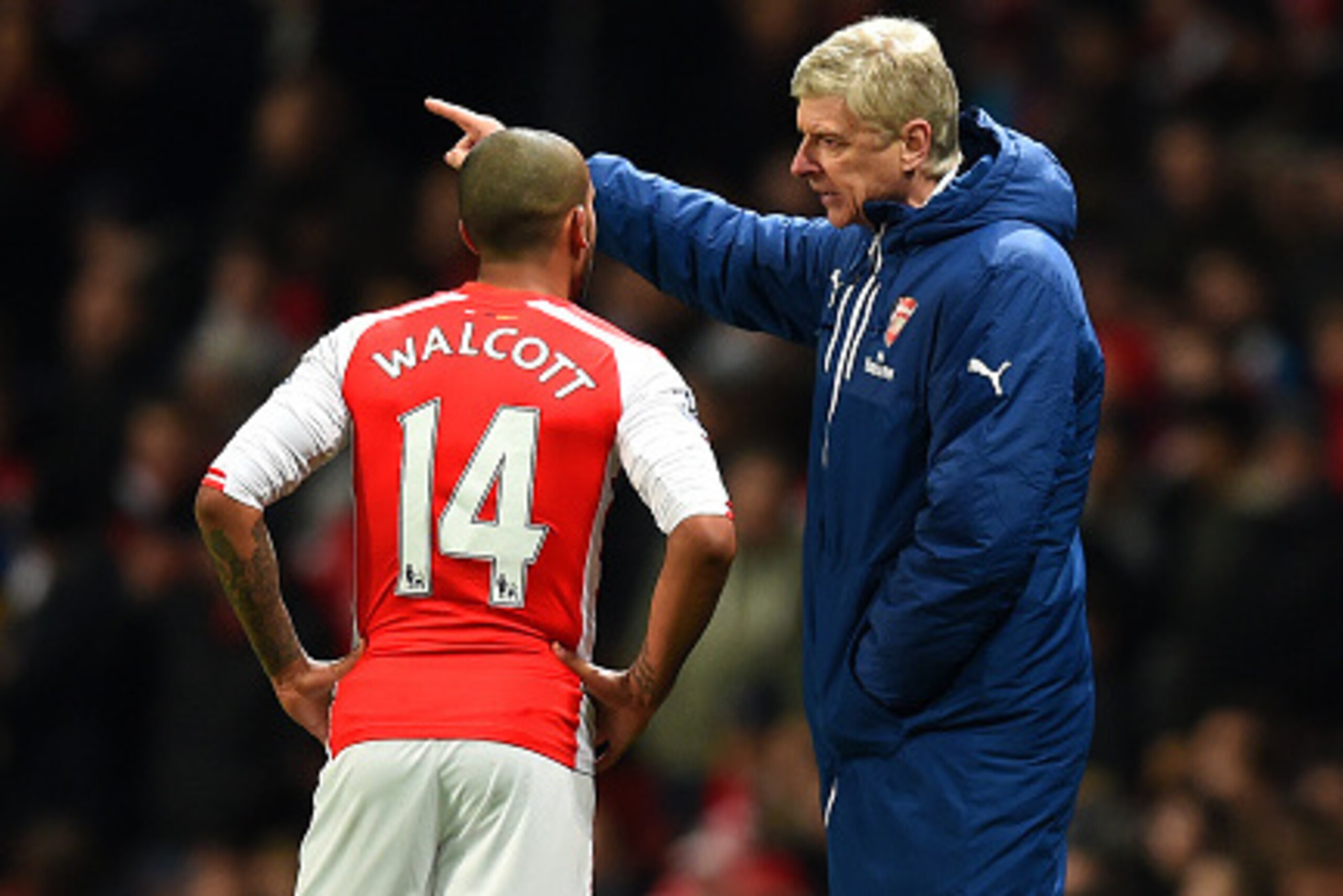 LONDON, ENGLAND - FEBRUARY 10:  Arsene Wenger, manager of Arsenal speaks with Theo Walcott of Arsenal during the Barclays Premier League match between Arsenal and Leicester City at Emirates Stadium on February 10, 2015 in London, England.  (Photo by Micha