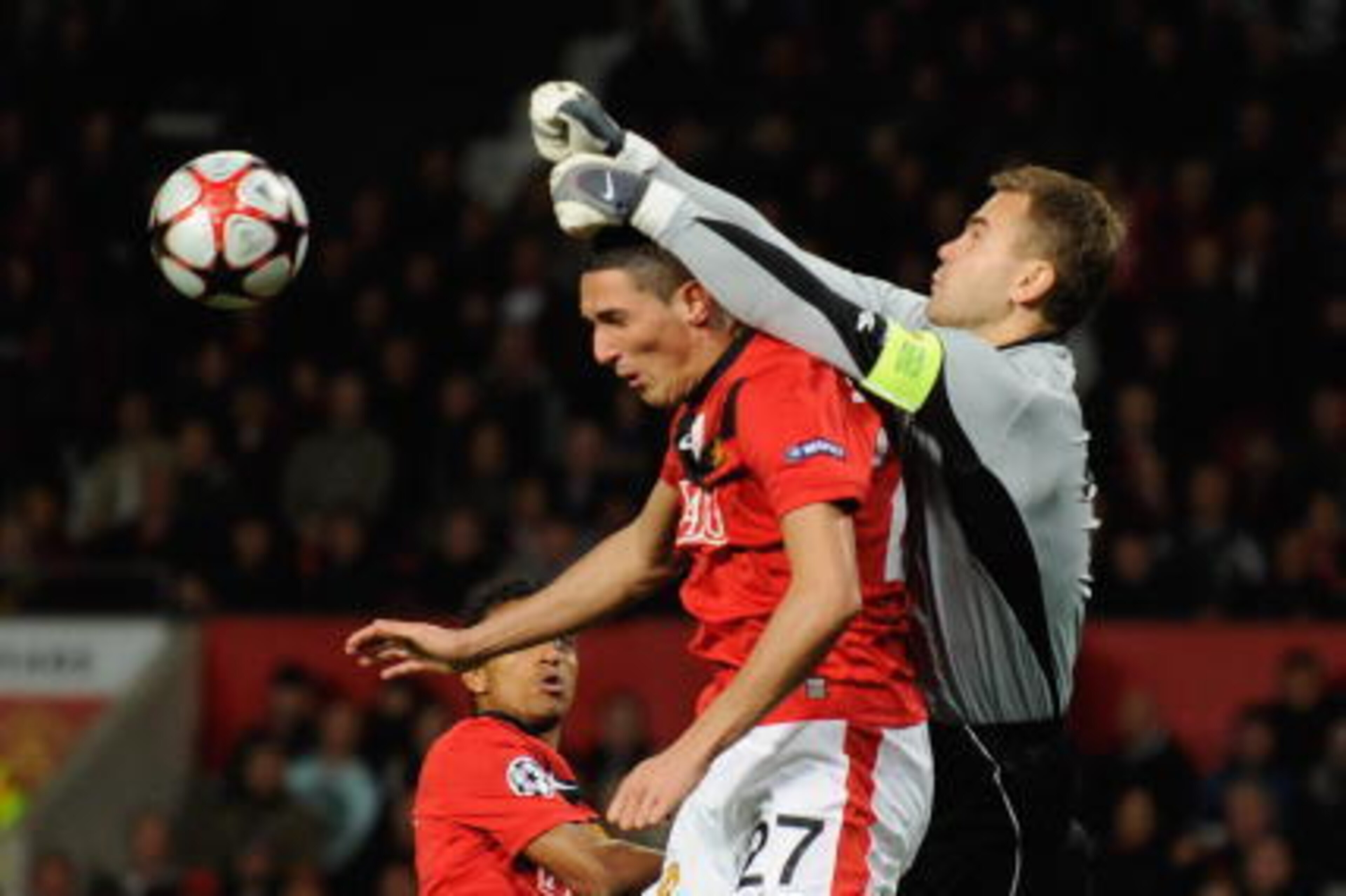 MANCHESTER, ENGLAND - NOVEMBER 03:  Igor Akinfeev of CSKA Moscow leaps to punch clear under pressure from Federico Macheda of Manchester United  during the UEFA Champions League Group B match between Manchester United and CSKA Moscow at Old Trafford on No