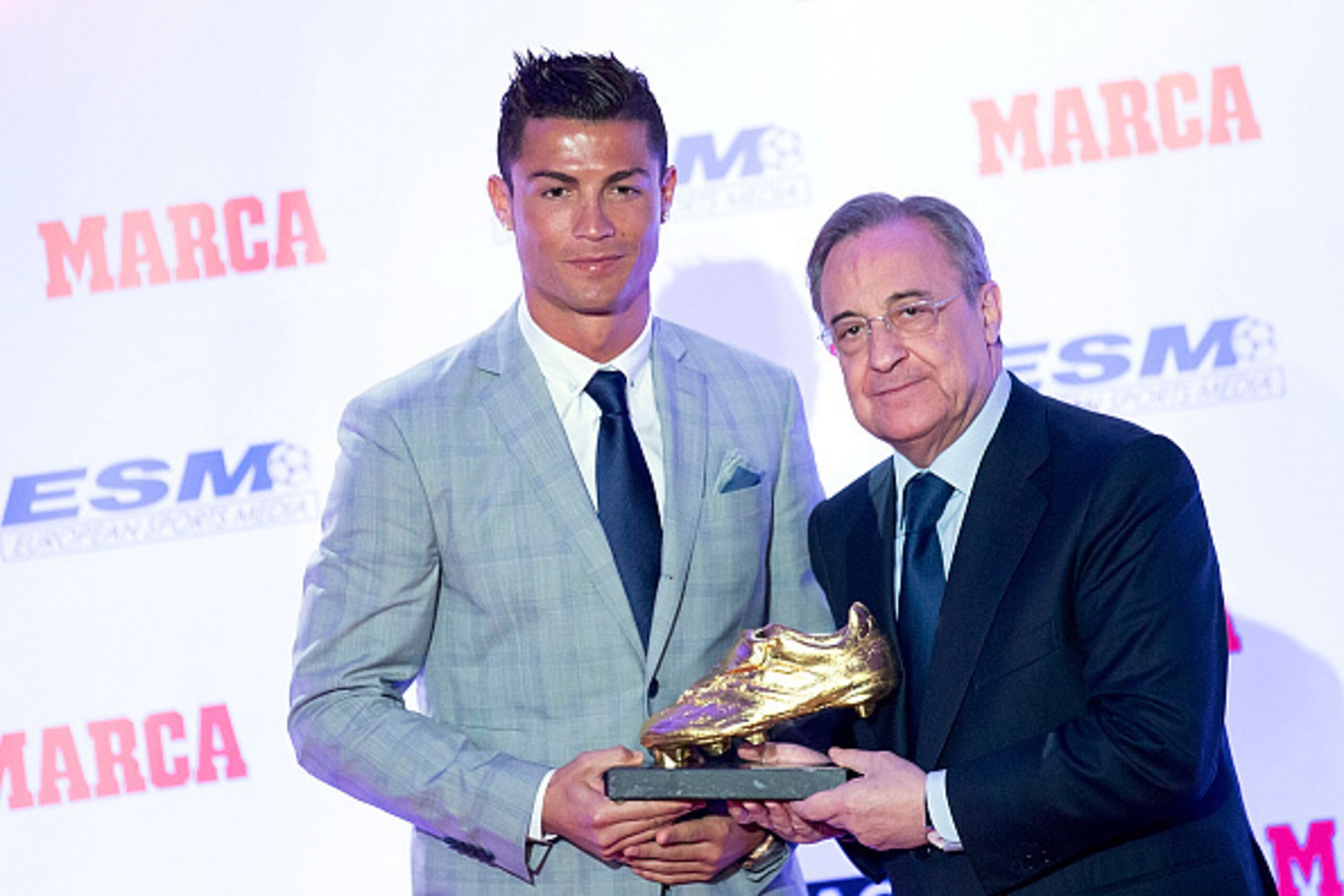 MADRID, SPAIN - OCTOBER 13:  Real Madrid football player Cristiano Ronaldo (L) receives from hands of Real Madrid president Florentino Perez (R) his fourth Golden Boot Award as maximun goal scorer of European leagues at The Westin Palace Hotel on October 
