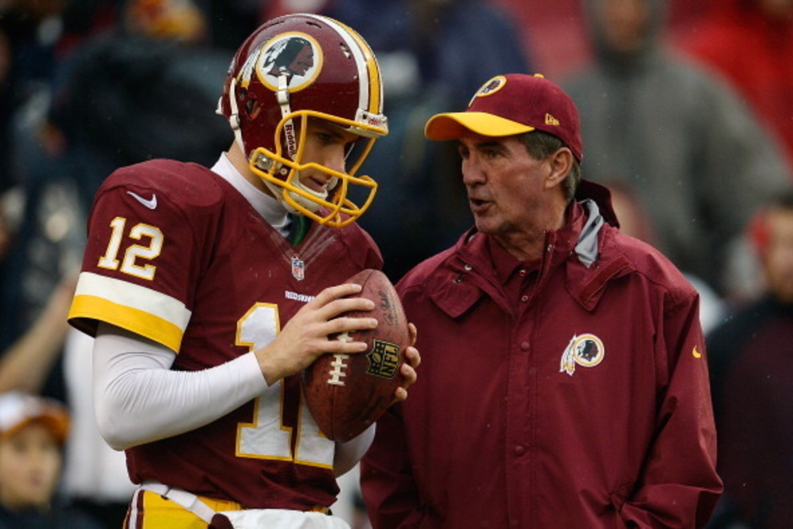 LANDOVER, MD - DECEMBER 22:  Quarterback Kirk Cousins #12 of the Washington Redskins talks with head coach Mike Shanahan during warmups prior to playing an NFL game against the Dallas Cowboys at FedExField on December 22, 2013 in Landover, Maryland.  (Pho