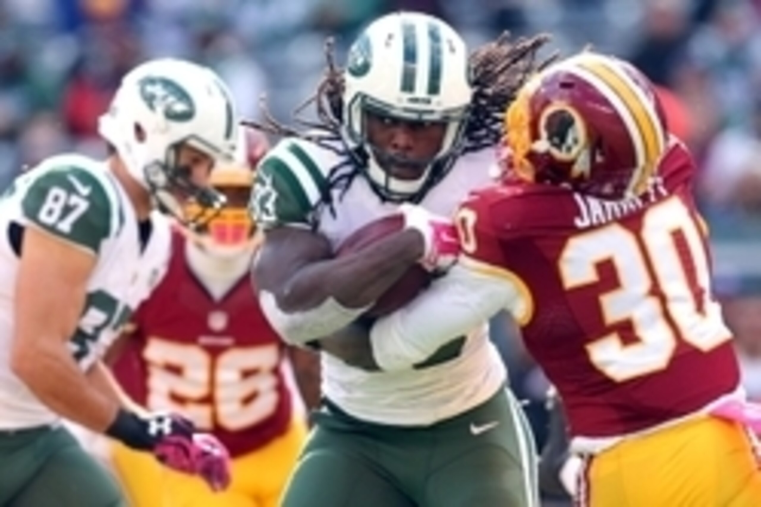 Oct 18, 2015; East Rutherford, NJ, USA; New York Jets running back Chris Ivory (33) carries the ball as Washington Redskins safety Kyshoen Jarrett (30) defends during the third quarter at MetLife Stadium. Mandatory Credit: Brad Penner-USA TODAY Sports
