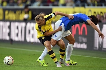Darmstadt's midfielder Marcel Heller and Dortmund's defender Marcel Schmelzer (L) vie for the ball during the German first division Bundesliga football match Borussia Dortmund v SV Darmstadt 98, in Dortmund, western Germany, on September 27, 2015. AFP PHO