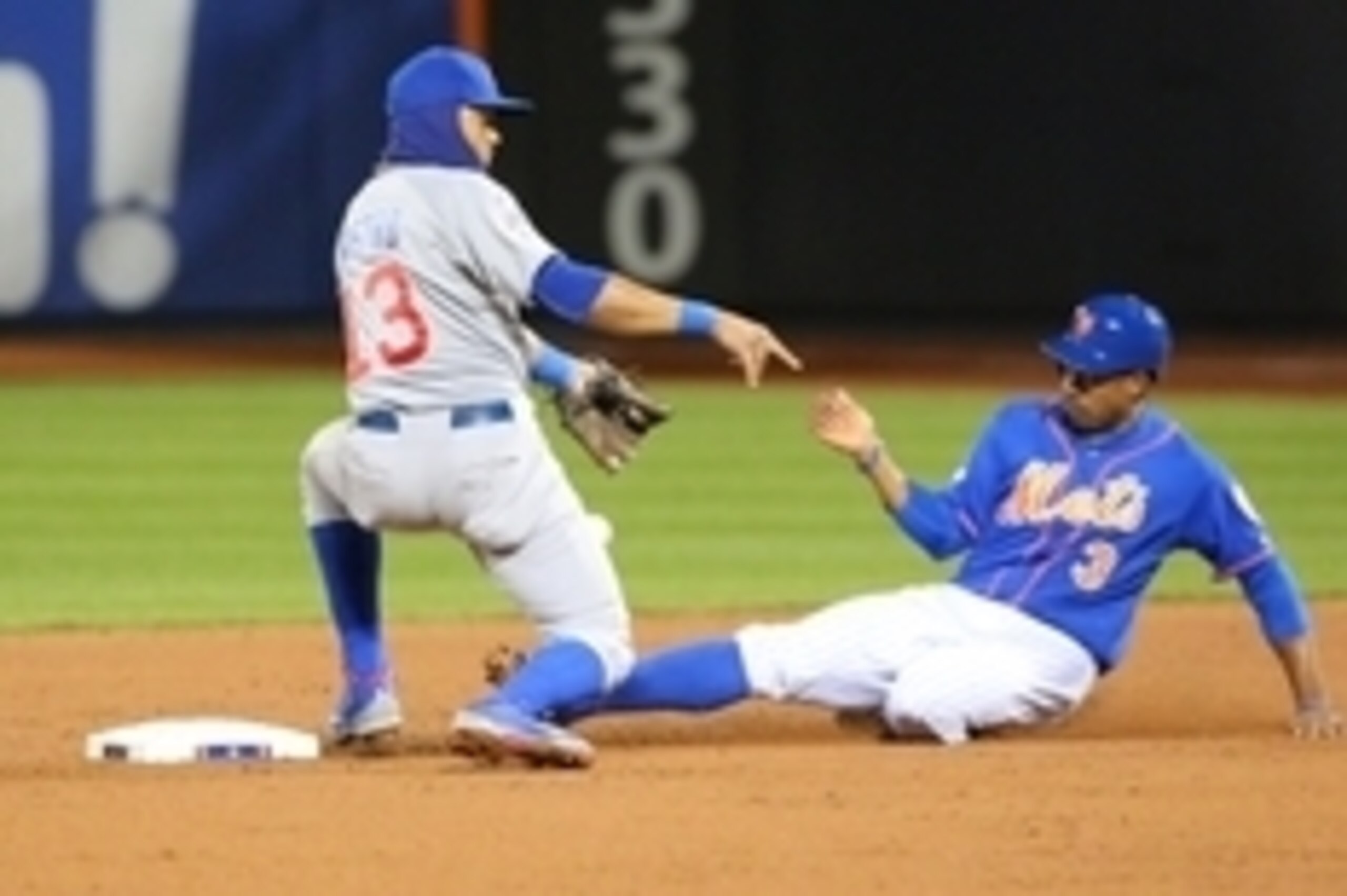 Oct 18, 2015; New York City, NY, USA; New York Mets right fielder Curtis Granderson (3) steals second base ahead of the throw to Chicago Cubs infielder Starlin Castro (13) in the third inning in game two of the NLCS at Citi Field. Mandatory Credit: Anthon