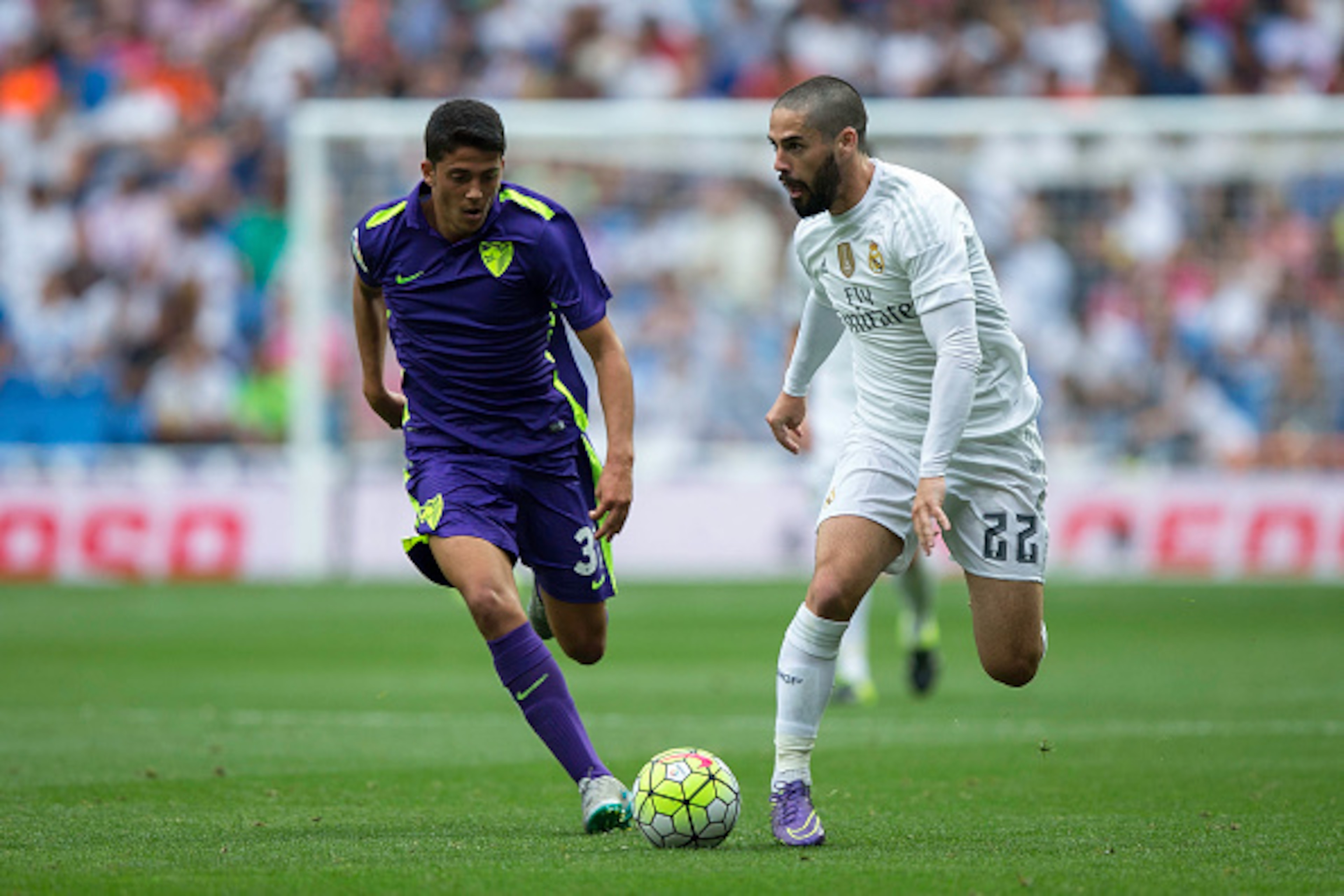 MADRID, SPAIN - SEPTEMBER 26: Isco (R) of Real Madrid CF competes for the ball with Pablo Fornals (L) of Malaga CF during the La Liga match between Real Madrid CF and Malaga CF at Estadio Santiago Bernabeu on September 26, 2015 in Madrid, Spain.  (Photo b