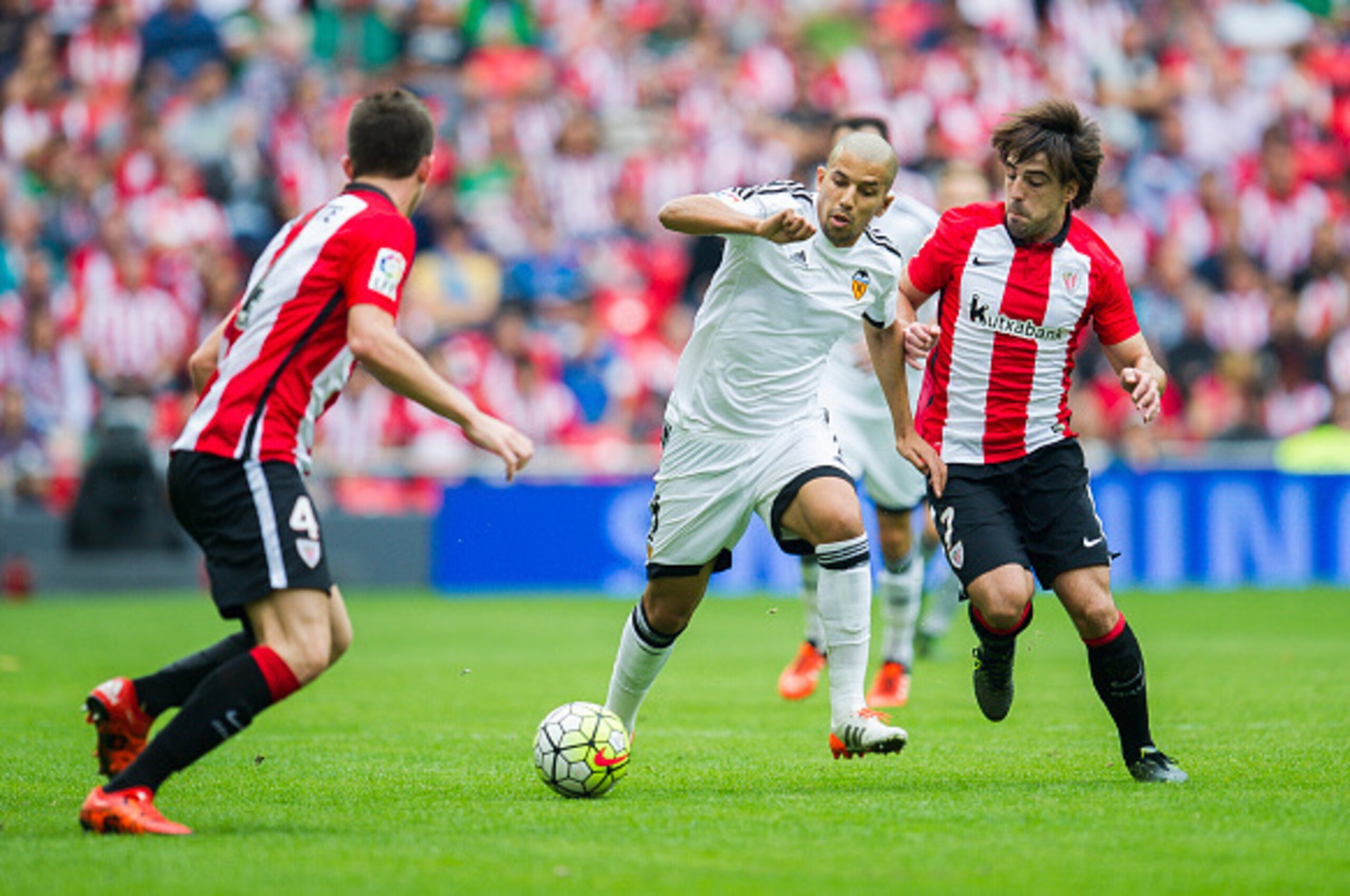 BILBAO, SPAIN - OCTOBER 04:  Sofiane Feghouli of Valencia CF duels for the ball with Benat Etxebarria of Athletic Club Bilbao during the La Liga match between Athletic Club Bilbao and Valencia CF at San Mames Stadium on October 4, 2015 in Bilbao, Spain.  