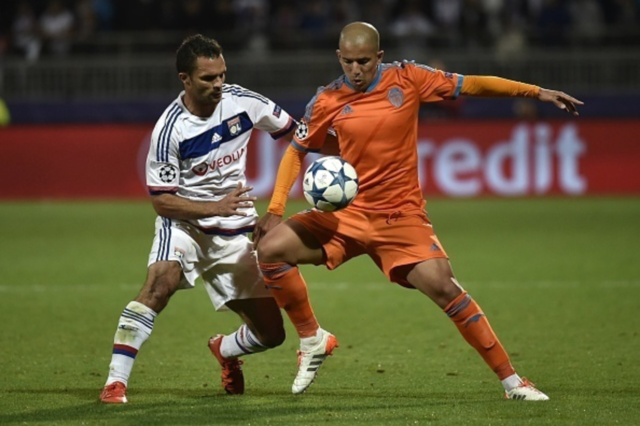 Valencia's Algerian midfielder Sofiane Feghouli (R) vies for the ball with Lyon's French defender Jeremy Morel during the Champions League group H football match between Lyon and Valencia on September 29, 2015 at the Gerland stadium in Lyon, central-easte