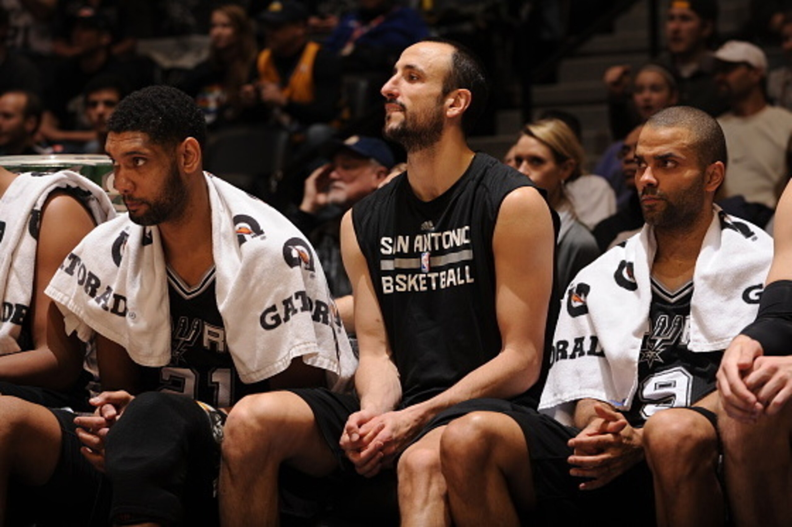 DENVER, CO - January 20: Tim Duncan #21, Manu Ginobili #20,  and Tony Parker #9 of the San Antonio Spurs sit on the sideline during a game against the Denver Nuggets on January 20, 2015 at the Pepsi Center in Denver, Colorado. NOTE TO USER: User expressly