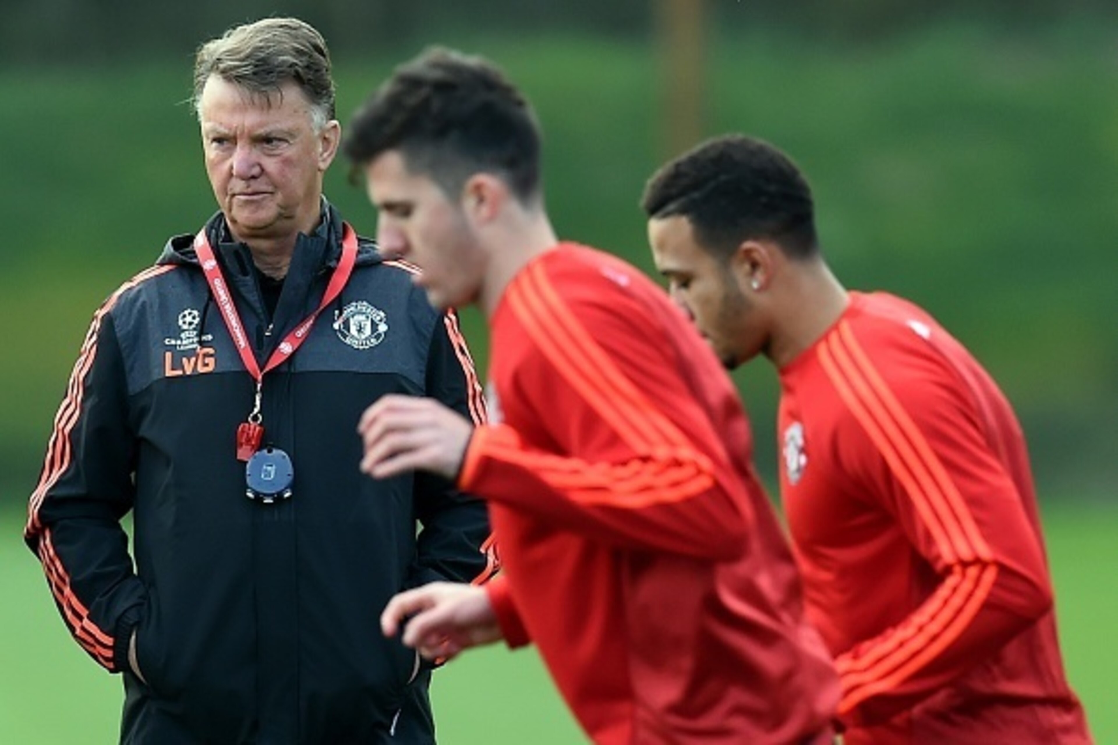 Manchester United's Dutch manager Louis van Gaal (L) watches a training session at their Carrington facility in Manchester, north west England on October 20, 2015 ahead of their Champions League football match against CSKA Moscow on October 21. AFP PHOTO 