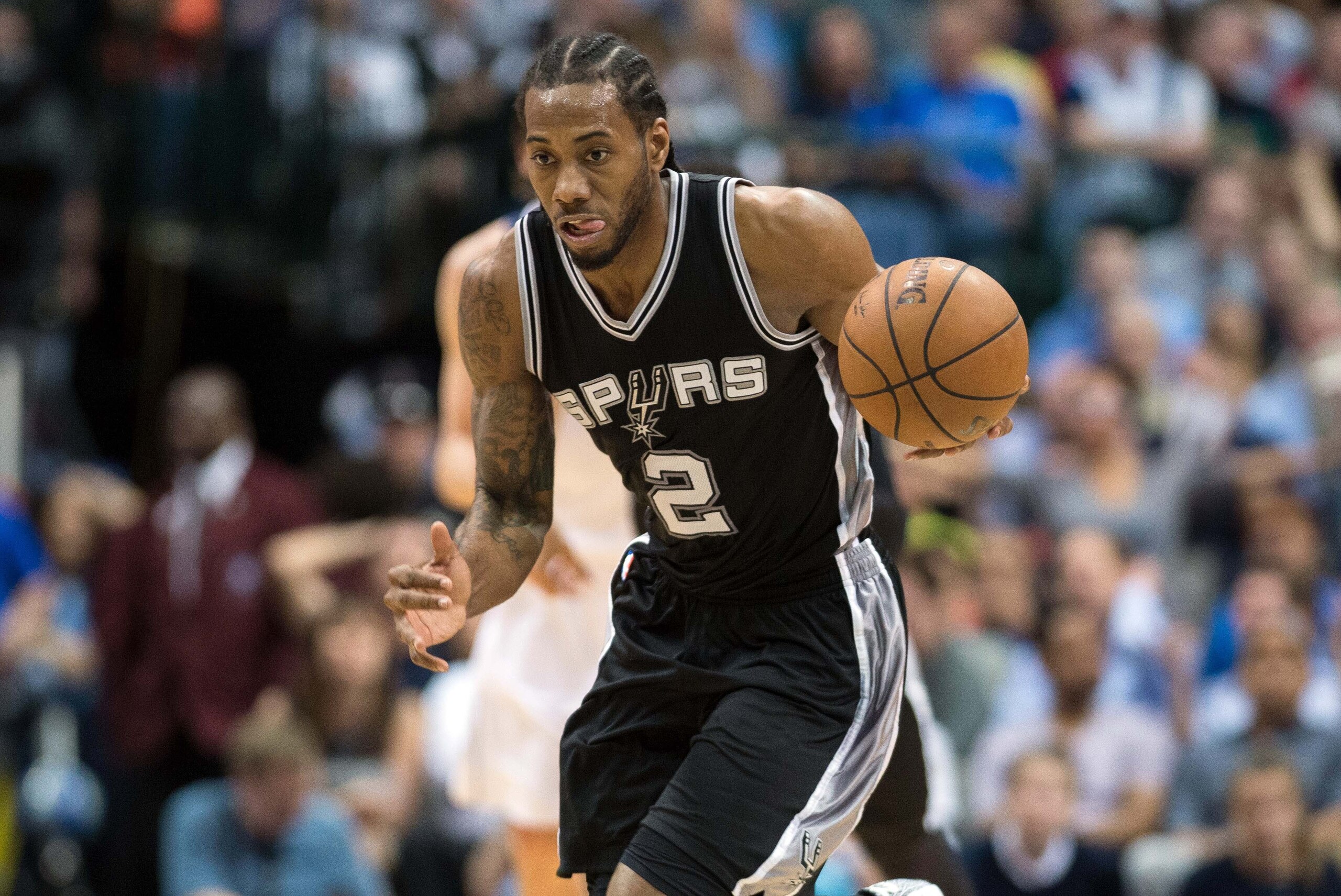 Mar 24, 2015; Dallas, TX, USA; San Antonio Spurs forward Kawhi Leonard (2) brings the ball up court during the game against the Dallas Mavericks at the American Airlines Center. The Mavericks defeated the Spurs 101-94. Mandatory Credit: Jerome Miron-USA T