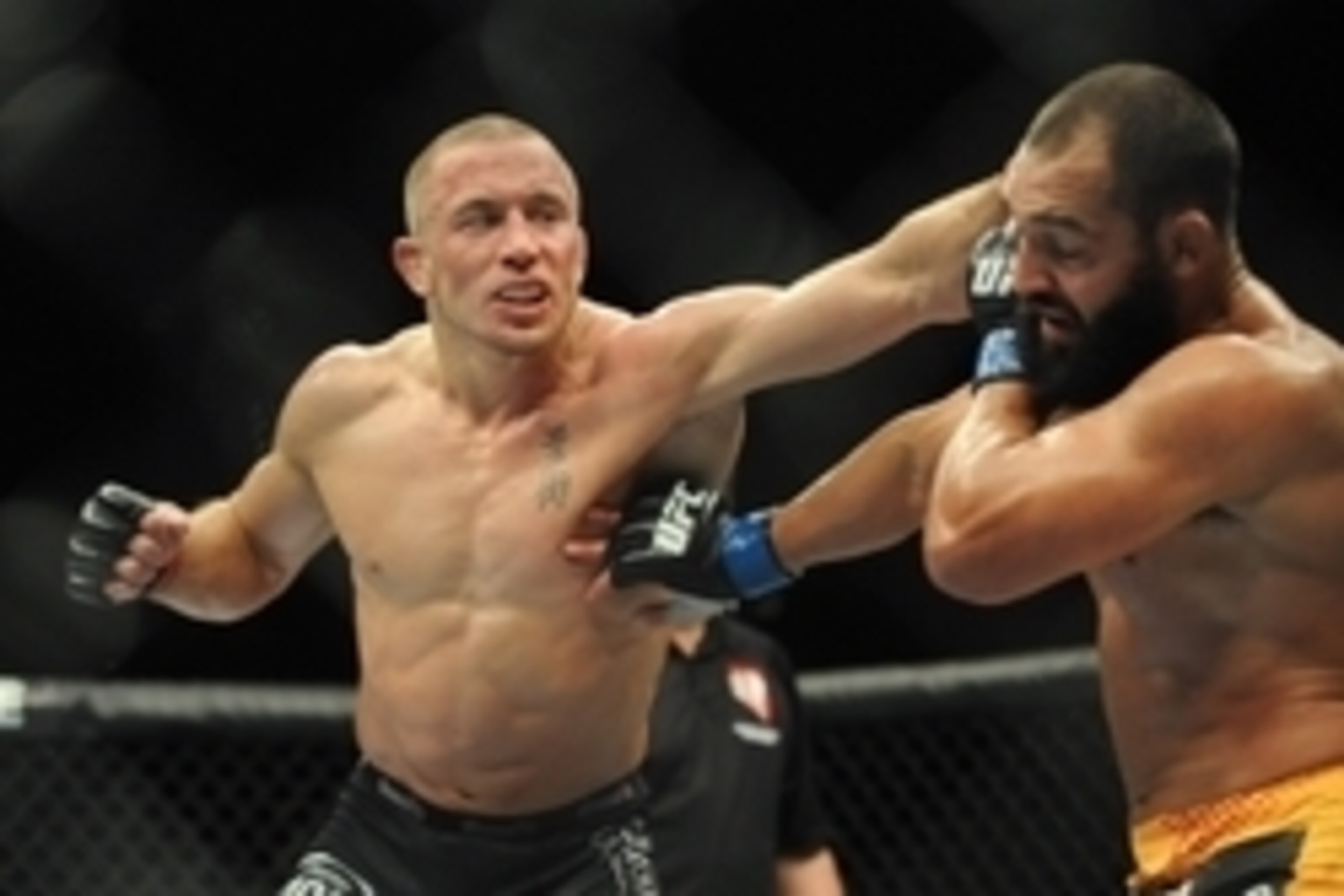 Nov 16, 2013; Las Vegas, NV, USA; Georges St-Pierre (red gloves) fights against Johny Hendricks (blue gloves) in their welterweight championship bout during UFC 167 at MGM Grand Garden Arena. Mandatory Credit: Stephen R. Sylvanie-USA TODAY Sports Nov 16, 2013; Las Vegas, NV, USA; Georges St-Pierre (red gloves) fights against Johny Hendricks (blue gloves) in their welterweight championship bout during UFC 167 at MGM Grand Garden Arena. Mandatory Credit: Stephen R. Sylvanie-USA TODAY Sports