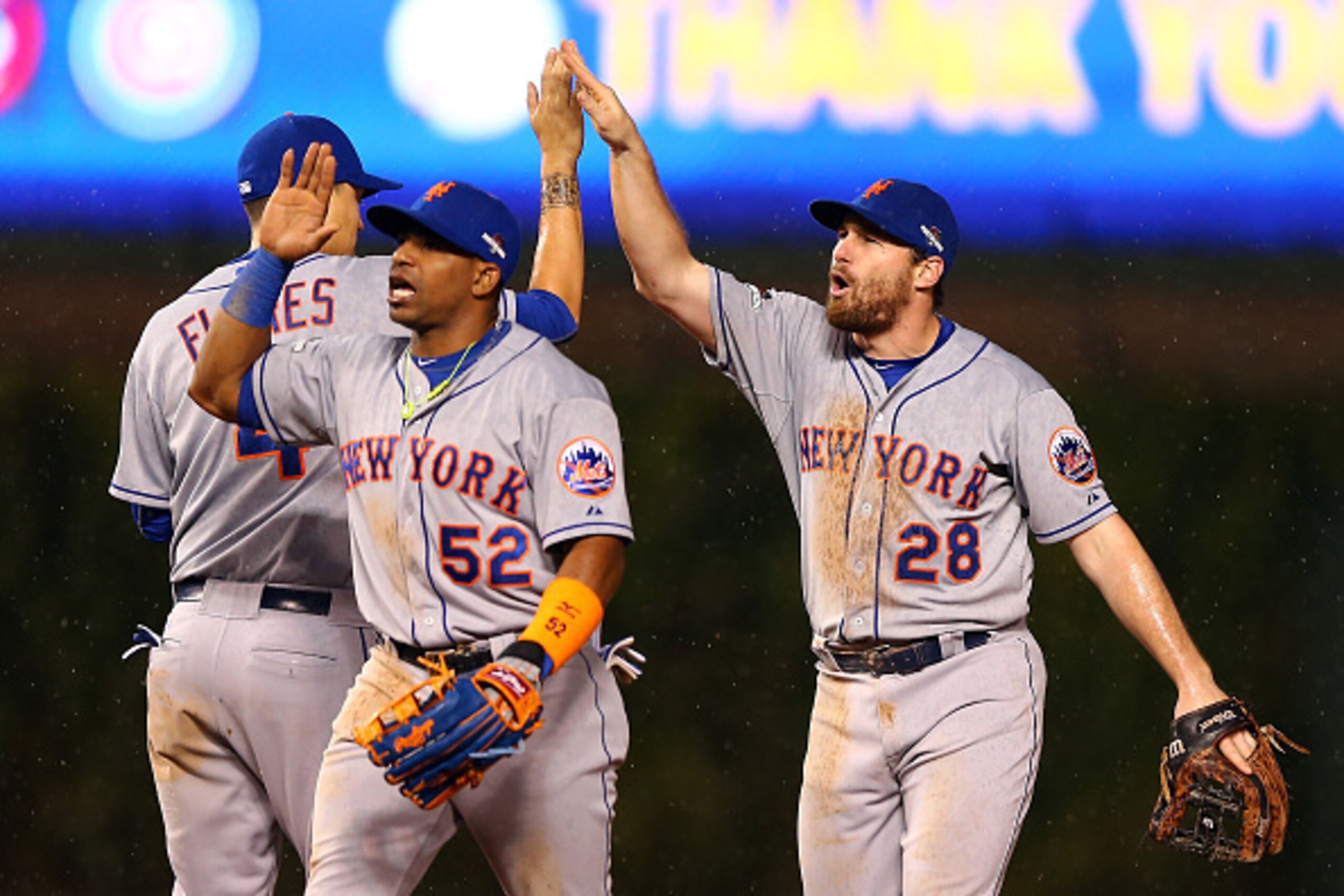 CHICAGO, IL - OCTOBER 20:  Daniel Murphy #28, Yoenis Cespedes #52 and Wilmer Flores #4 of the New York Mets celebrate after defeating the Chicago Cubs in game three of the 2015 MLB National League Championship Series at Wrigley Field on October 20, 2015 i