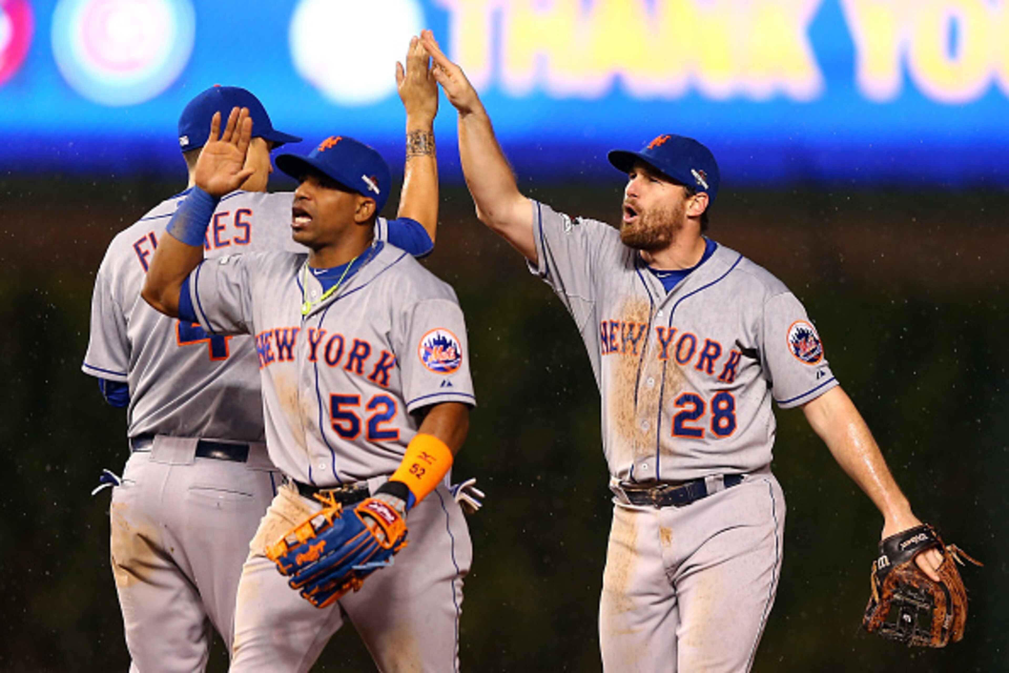 CHICAGO, IL - OCTOBER 20: Daniel Murphy #28, Yoenis Cespedes #52 and Wilmer Flores #4 of the New York Mets celebrate after defeating the Chicago Cubs in game three of the 2015 MLB National League Championship Series at Wrigley Field on October 20, 2015 i CHICAGO, IL - OCTOBER 20: Daniel Murphy #28, Yoenis Cespedes #52 and Wilmer Flores #4 of the New York Mets celebrate after defeating the Chicago Cubs in game three of the 2015 MLB National League Championship Series at Wrigley Field on October 20, 2015 i