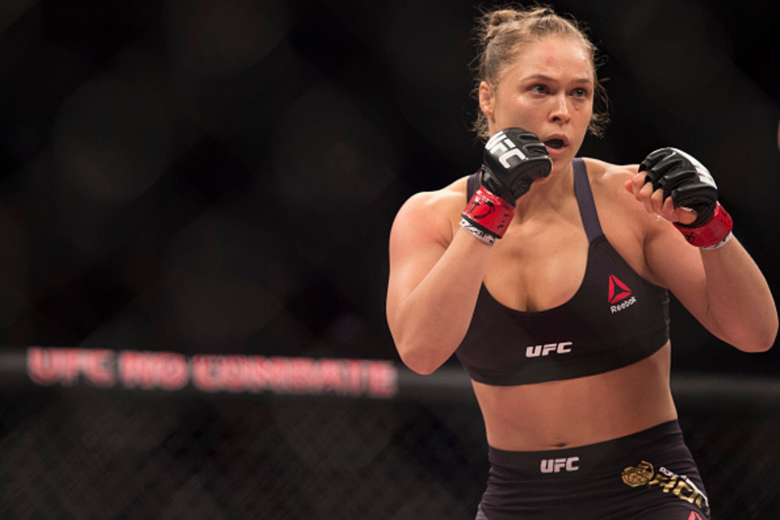 RIO DE JANEIRO, BRAZIL - AUGUST 01: UFC women's bantamweight champion Ronda Rousey of the United States rushes forward against Bethe Correia of Brazil during the UFC 190 event inside HSBC Arena on August 1, 2015 in Rio de Janeiro, Brazil. (Photo by Jeff RIO DE JANEIRO, BRAZIL - AUGUST 01: UFC women's bantamweight champion Ronda Rousey of the United States rushes forward against Bethe Correia of Brazil during the UFC 190 event inside HSBC Arena on August 1, 2015 in Rio de Janeiro, Brazil. (Photo by Jeff
