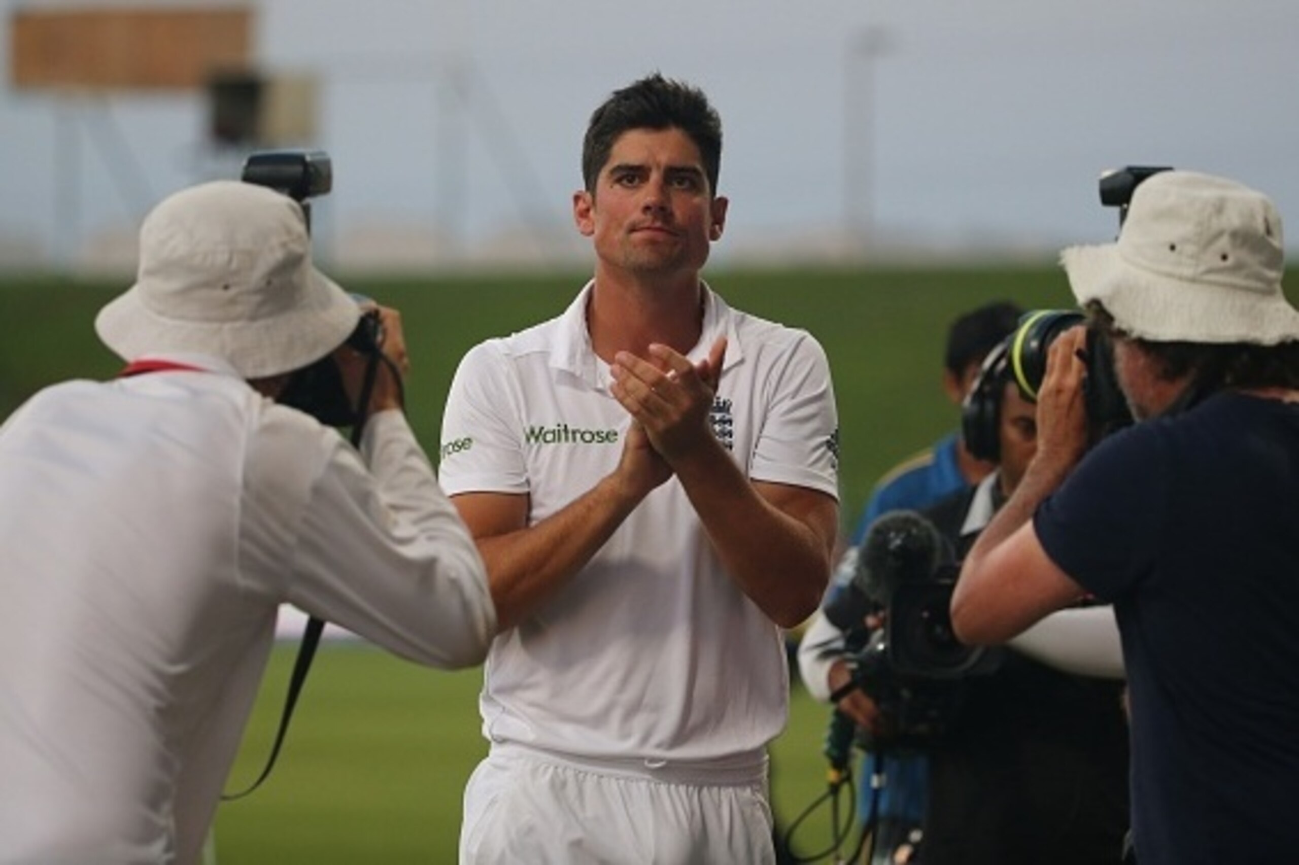 England's Alastair Cook (C) is photographed as he applauds the crowd at the end of the fifth and final day's play of the first cricket Test match between Pakistan and England at The Sheikh Zayed International Cricket Stadium in Abu Dhabi on October 17, 20