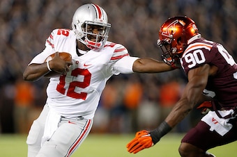 BLACKSBURG, VA - SEPTEMBER 7: Cardale Jones #12 of the Ohio State Buckeyes tries to run the ball past Dadi L'homme Nicolas #90 of the Virginia Tech Hokies in the first quarter at Lane Stadium on September 7, 2015 in Blacksburg, Virginia. (Photo by Joe Rob