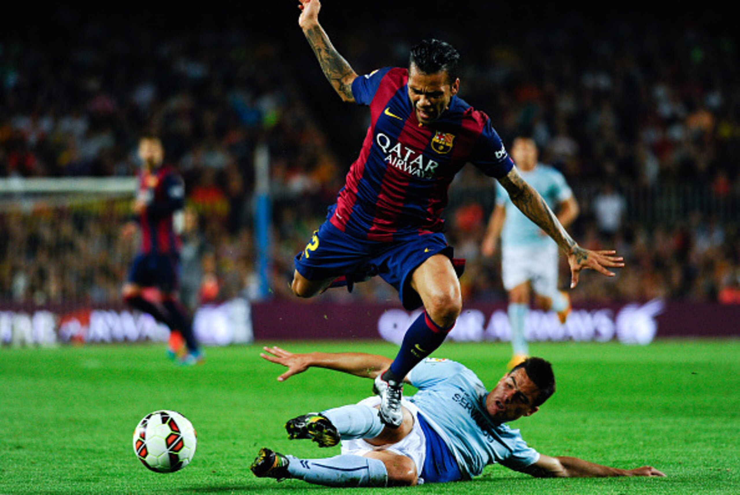 BARCELONA, SPAIN - OCTOBER 18:  Dani Alves of FC Barcelona duels for the ball with Dani Garcia of SD Eibar during the La Liga match between FC Barcelona and SD Eibar at Camp Nou on October 18, 2014 in Barcelona, Spain.  (Photo by Sandra Montanez/Getty Ima