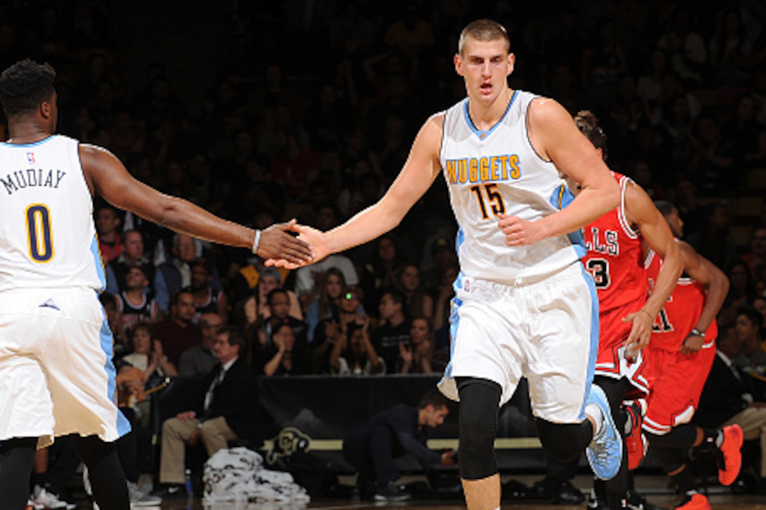 BOULDER, CO - OCTOBER 8:  Emmanuel Mudiay #0 of the Denver Nuggets shakes hands with Nikola Jokic #15 of the Denver Nuggets during a preseason game against the Chicago Bulls on October 8, 2015 at the Coors Event Center in Boulder, Colorado. NOTE TO USER: 