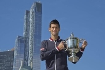 Sep 14, 2015; New York, NY, USA; Novak Djokovic of Serbia poses with the championship trophy in Central Park the day after winning the 2015 U.S. Open tennis tournament. Mandatory Credit: Susan Mullane-USA TODAY Sports