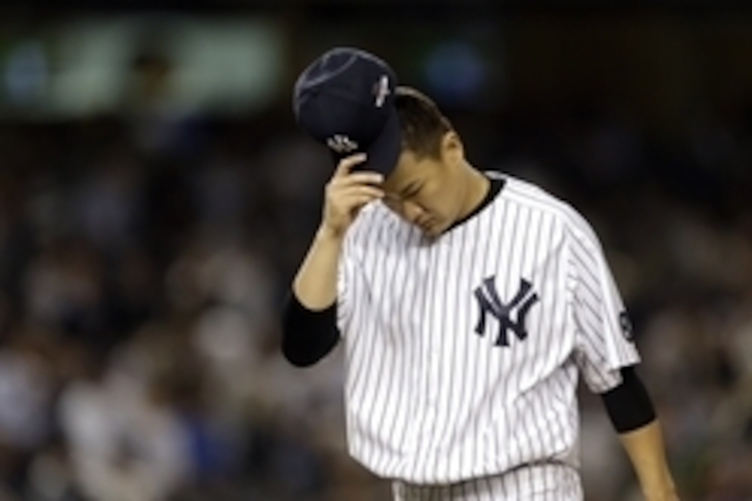 Oct 6, 2015; Bronx, NY, USA; New York Yankees starting pitcher Masahiro Tanaka (19) reacts after the second inning against the Houston Astros in the American League Wild Card playoff baseball game at Yankee Stadium. Mandatory Credit: Adam Hunger-USA TODAY
