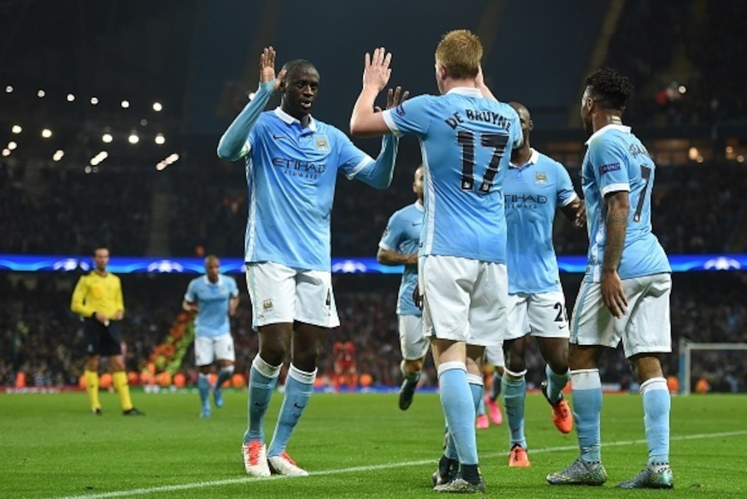 Manchester City's Belgian midfielder Kevin De Bruyne (C) celebrates with teammates after scoring during a UEFA Champions league Group D football match between Manchester City and Sevilla at the Etihad Stadium in Manchester, north west England on October 2