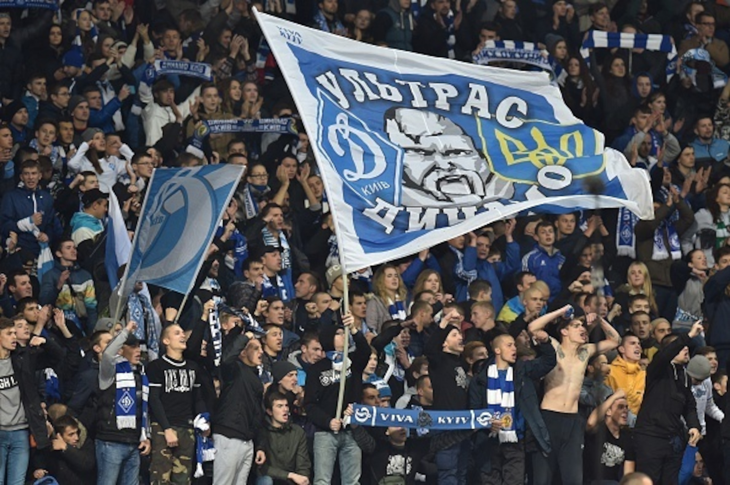 Dynamo Kiev's supporters cheer their team during the UEFA Champions League football match Dynamo Kiev vs Chelsea, on October 20, 2015 at the Olympic stadium in Kiev.    AFP PHOTO / GENYA SAVILOV        (Photo credit should read GENYA SAVILOV/AFP/Getty Ima