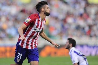Atletico Madrid's Belgian midfielder Yannick Ferreira Carrasco celebrates after scoring during the Spanish league football match Real Sociedad de Futbol vs Club Atletico de Madrid at the Anoeta stadium in San Sebastian on October 18, 2015. Atletico won th