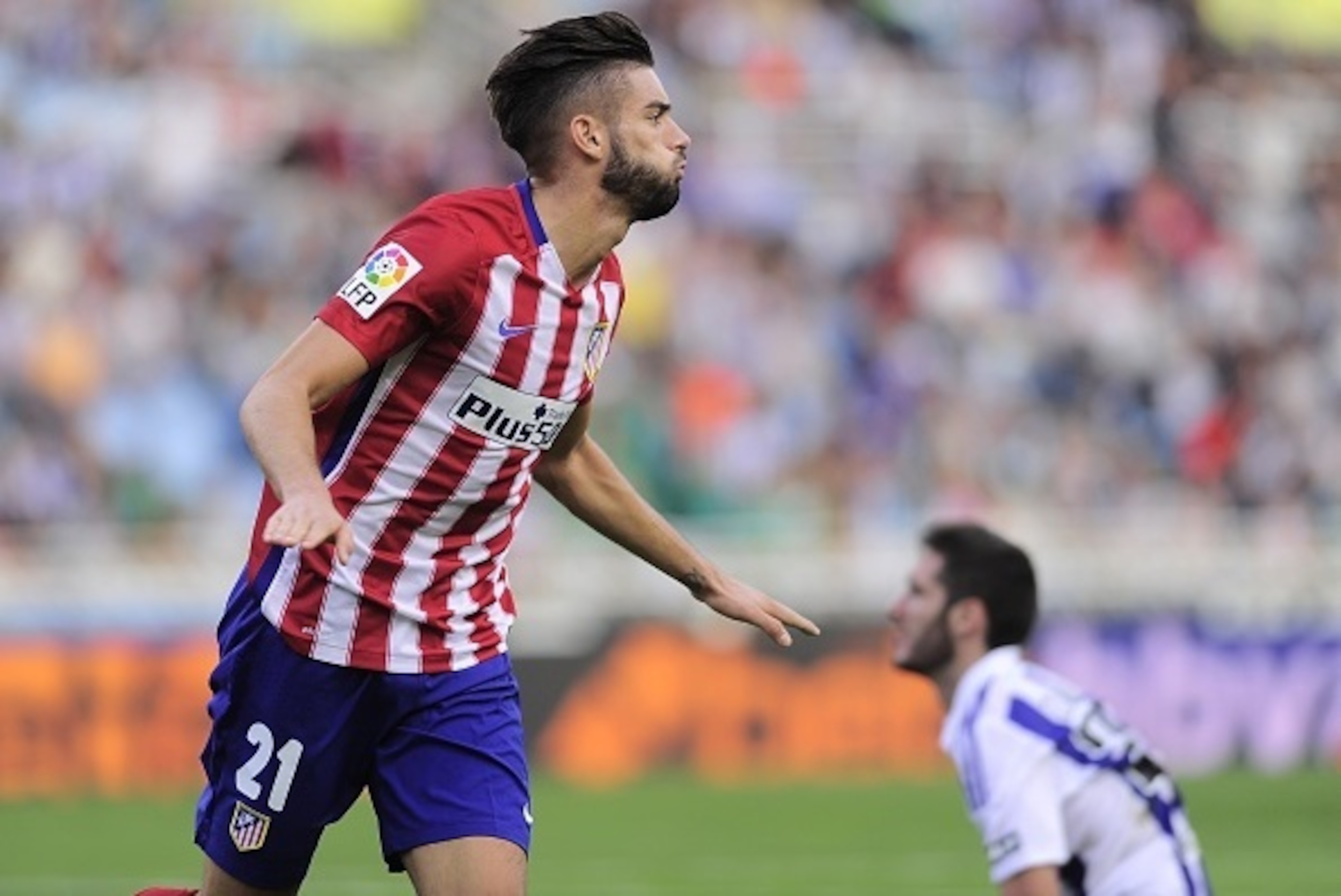 Atletico Madrid's Belgian midfielder Yannick Ferreira Carrasco celebrates after scoring during the Spanish league football match Real Sociedad de Futbol vs Club Atletico de Madrid at the Anoeta stadium in San Sebastian on October 18, 2015. Atletico won th