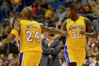 Oct 8, 2015; Ontario, CA, USA; Los Angeles Lakers guard Kobe Bryant (24) and forward Julius Randle (30) react during the game against the Toronto Raptors at Citizens Business Bank Arena. Mandatory Credit: Jayne Kamin-Oncea-USA TODAY Sports