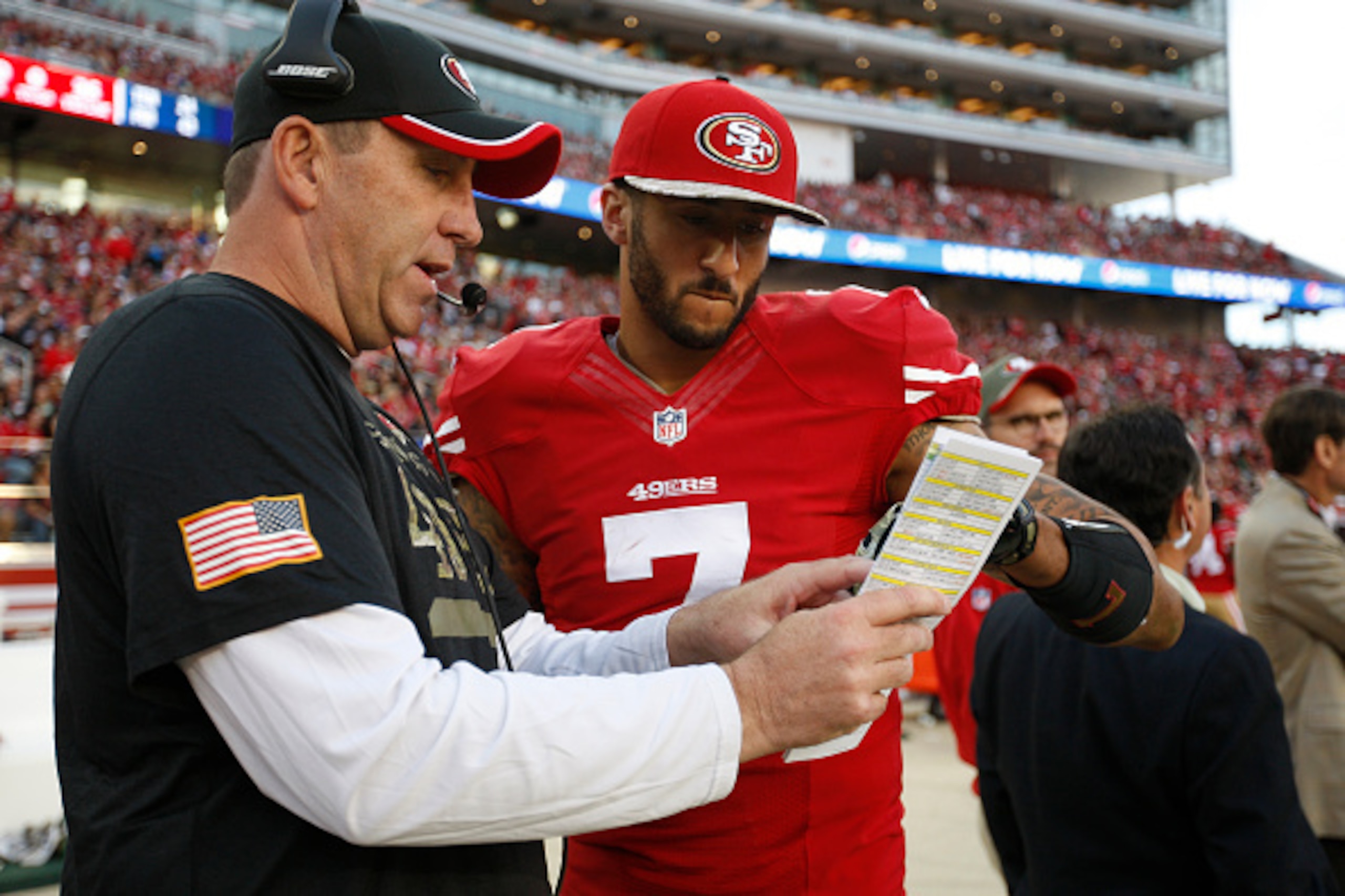 SANTA CLARA, CA - NOVEMBER 23: Quarterbacks Coach Geep Chryst of the San Francisco 49ers talks with Colin Kaepernick #7 during the game against the Washington Redskins at Levi Stadium on November 23, 2014 in Santa Clara, California. The 49ers defeated the