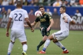 Oct 18, 2015; Carson, CA, USA; Portland Timbers forward Lucas Melano (center) attempts a shots defended by Los Angeles Galaxy defender Omar Gonzalez (right) during the first half at StubHub Center. Mandatory Credit: Kelvin Kuo-USA TODAY Sports