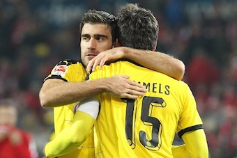 Dortmund's Greek defender Sokratis (L) and Dortmund's defender Mats Hummels celebrate after the German first division Bundesliga football match FSV Mainz 05 vs Borussia Dortmund in Mainz, western Germany, on October 16, 2015. Dortmund won the match 0-2.  
