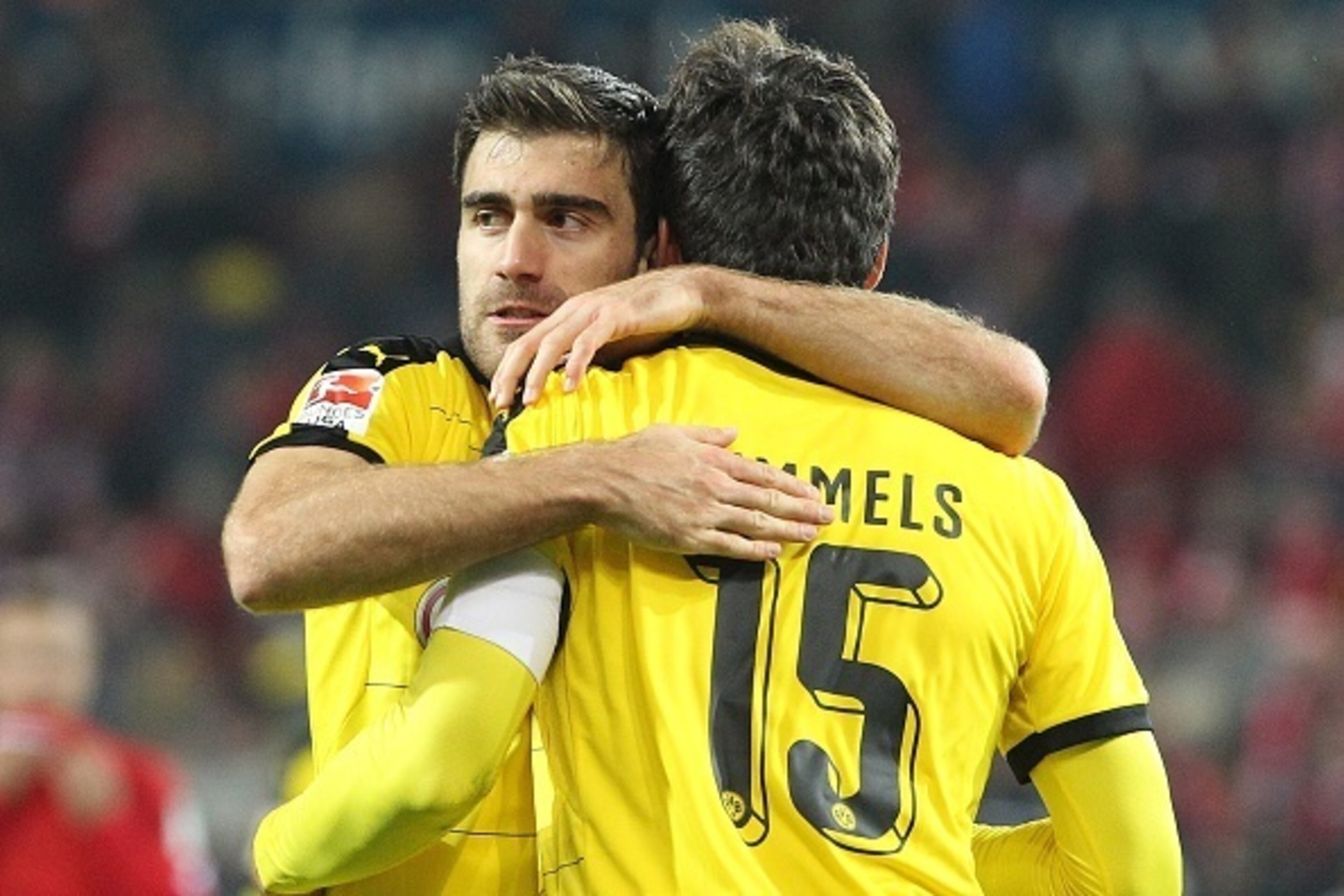 Dortmund's Greek defender Sokratis (L) and Dortmund's defender Mats Hummels celebrate after the German first division Bundesliga football match FSV Mainz 05 vs Borussia Dortmund in Mainz, western Germany, on October 16, 2015. Dortmund won the match 0-2.  
