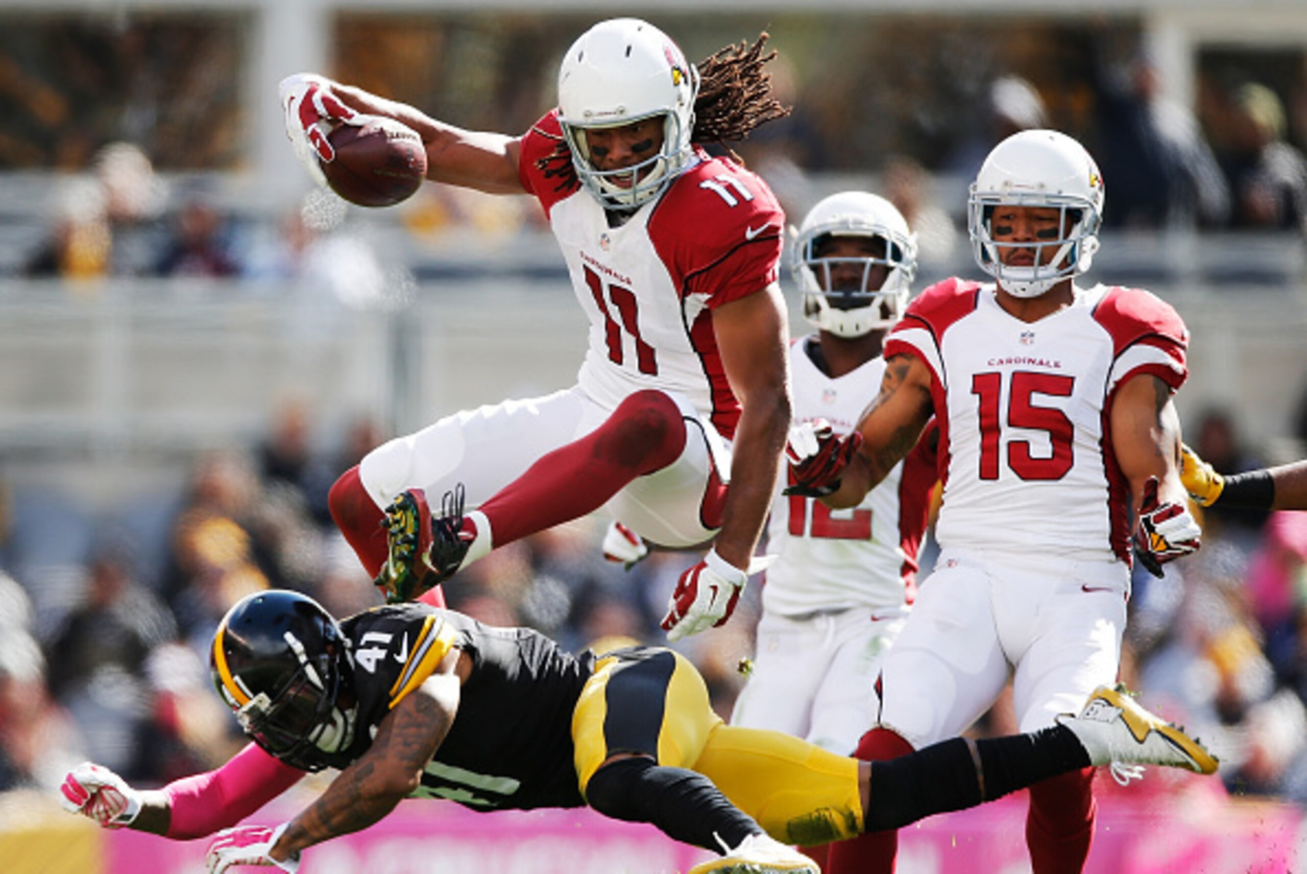 PITTSBURGH, PA - OCTOBER 18:  Larry Fitzgerald #11 of the Arizona Cardinals leaps over Antwon Blake #41 of the Pittsburgh Steelers in the 1st half of the gmae at Heinz Field on October 18, 2015 in Pittsburgh, Pennsylvania.  (Photo by Gregory Shamus/Getty 